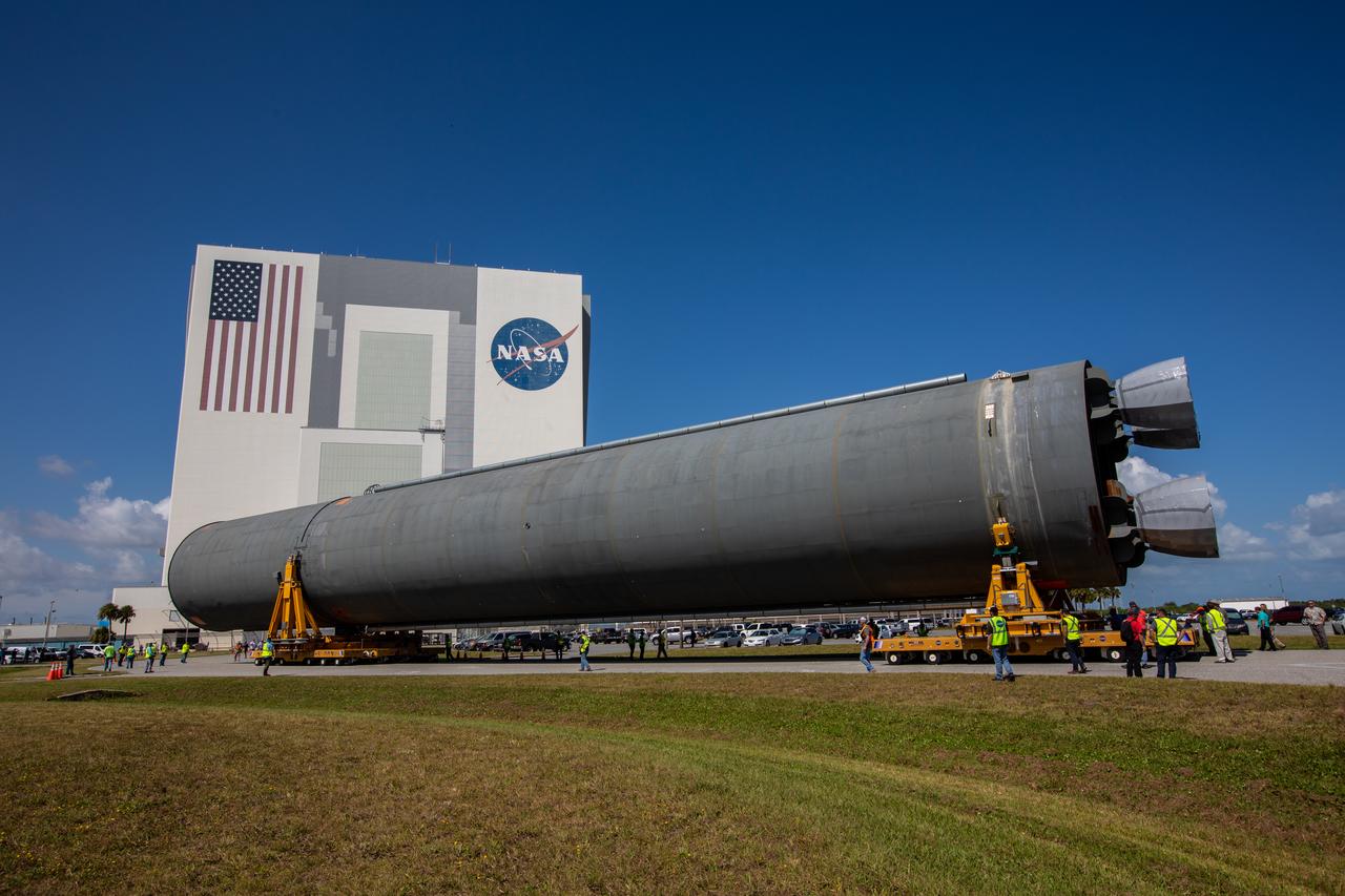 The 212-foot-long Space Launch System (SLS) rocket core stage pathfinder is being transported to the Vehicle Assembly Building at NASA’s Kennedy Space Center in Florida on Oct. 1, 2019. NASA's Pegasus Barge arrived at the Launch Complex 39 turn basin wharf on Sept. 30, 2019, making its first delivery to Kennedy in support of the agency's Artemis missions. The upgraded 310-foot-long barge arrived Sept. 27, 2019, ferrying the SLS core stage pathfinder, a full-scale mock-up of the rocket's core stage. The pathfinder will be used by the Exploration Ground Systems Program and their contractor, Jacobs, to practice offloading, moving and stacking maneuvers, using important ground support equipment to train employees and certify all the equipment works properly. The pathfinder will stay at Kennedy for approximately one month before trekking back to NASA's Michoud Assembly Facility in Louisiana.