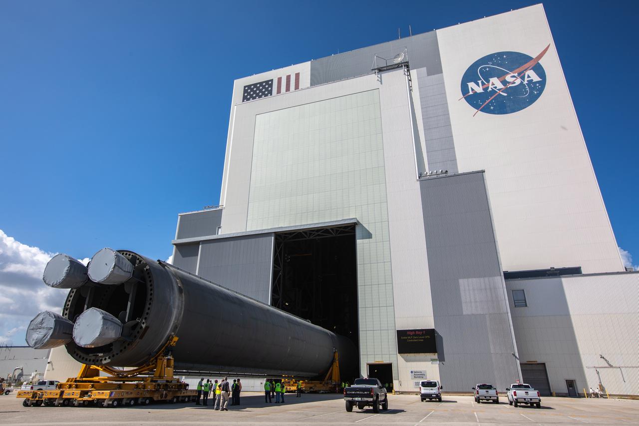 The 212-foot-long Space Launch System (SLS) rocket core stage pathfinder is moved into the low bay of the Vehicle Assembly Building at NASA’s Kennedy Space Center in Florida on Oct. 1, 2019. NASA's Pegasus Barge arrived at the Launch Complex 39 turn basin wharf on Sept. 30, 2019, making its first delivery to Kennedy in support of the agency's Artemis missions. The upgraded 310-foot-long barge arrived Sept. 27, 2019, ferrying the SLS core stage pathfinder, a full-scale mock-up of the rocket's core stage. The pathfinder will be used by the Exploration Ground Systems Program and their contractor, Jacobs, to practice offloading, moving and stacking maneuvers, using important ground support equipment to train employees and certify all the equipment works properly. The pathfinder will stay at Kennedy for approximately one month before trekking back to NASA's Michoud Assembly Facility in Louisiana.