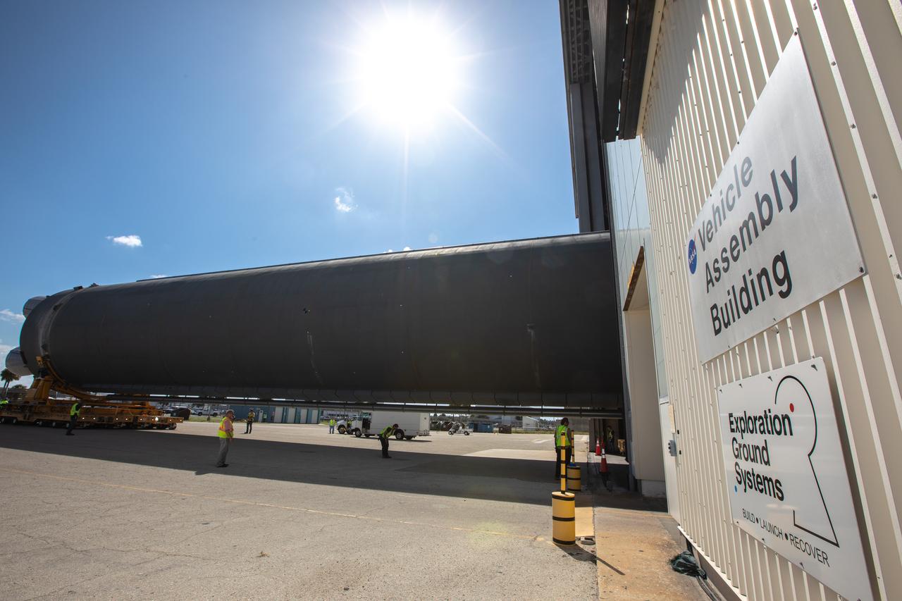 The 212-foot-long Space Launch System (SLS) rocket core stage pathfinder is moved into the low bay of the Vehicle Assembly Building at NASA’s Kennedy Space Center in Florida on Oct. 1, 2019. NASA's Pegasus Barge arrived at the Launch Complex 39 turn basin wharf on Sept. 30, 2019, making its first delivery to Kennedy in support of the agency's Artemis missions. The upgraded 310-foot-long barge arrived Sept. 27, 2019, ferrying the SLS core stage pathfinder, a full-scale mock-up of the rocket's core stage. The pathfinder will be used by the Exploration Ground Systems Program and their contractor, Jacobs, to practice offloading, moving and stacking maneuvers, using important ground support equipment to train employees and certify all the equipment works properly. The pathfinder will stay at Kennedy for approximately one month before trekking back to NASA's Michoud Assembly Facility in Louisiana.