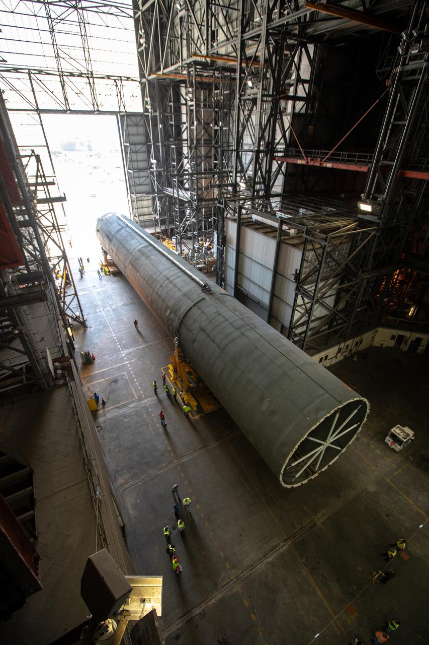 The 212-foot-long Space Launch System (SLS) rocket core stage pathfinder is inside the low bay of the Vehicle Assembly Building at NASA’s Kennedy Space Center in Florida on Oct. 1, 2019. NASA's Pegasus Barge arrived at the Launch Complex 39 turn basin wharf on Sept. 30, 2019, making its first delivery to Kennedy in support of the agency's Artemis missions. The upgraded 310-foot-long barge arrived Sept. 27, 2019, ferrying the SLS core stage pathfinder, a full-scale mock-up of the rocket's core stage. The pathfinder will be used by the Exploration Ground Systems Program and their contractor, Jacobs, to practice offloading, moving and stacking maneuvers, using important ground support equipment to train employees and certify all the equipment works properly. The pathfinder will stay at Kennedy for approximately one month before trekking back to NASA's Michoud Assembly Facility in Louisiana.