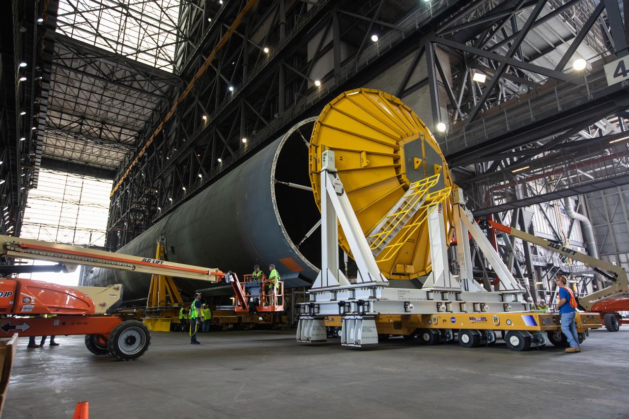 Inside the Vehicle Assembly Building at NASA’s Kennedy Space Center in Florida, operations are underway to attach a cover, called a spider, to the top of the Space Launch System (SLS) Core Stage pathfinder on Oct. 3, 2019. With the spider secured in place, a crane will be attached to it to lift the pathfinder into the vertical position. The 212-foot-long core stage pathfinder arrived in NASA's Pegasus Barge at Kennedy’s Launch Complex 39 turn basin wharf on Sept. 27, 2019. The Pegasus Barge made its first delivery to Kennedy in support of the agency's Artemis missions. The upgraded 310-foot-long barge arrived, ferrying the SLS core stage pathfinder, a full-scale mock-up of the rocket's core stage. It will be used by Exploration Ground Systems and its contractor, Jacobs, to practice offloading, moving and stacking maneuvers, using important ground support equipment to train employees and certify all the equipment works properly. The pathfinder will stay at Kennedy for approximately one month before trekking back to NASA's Michoud Assembly Facility in Louisiana.