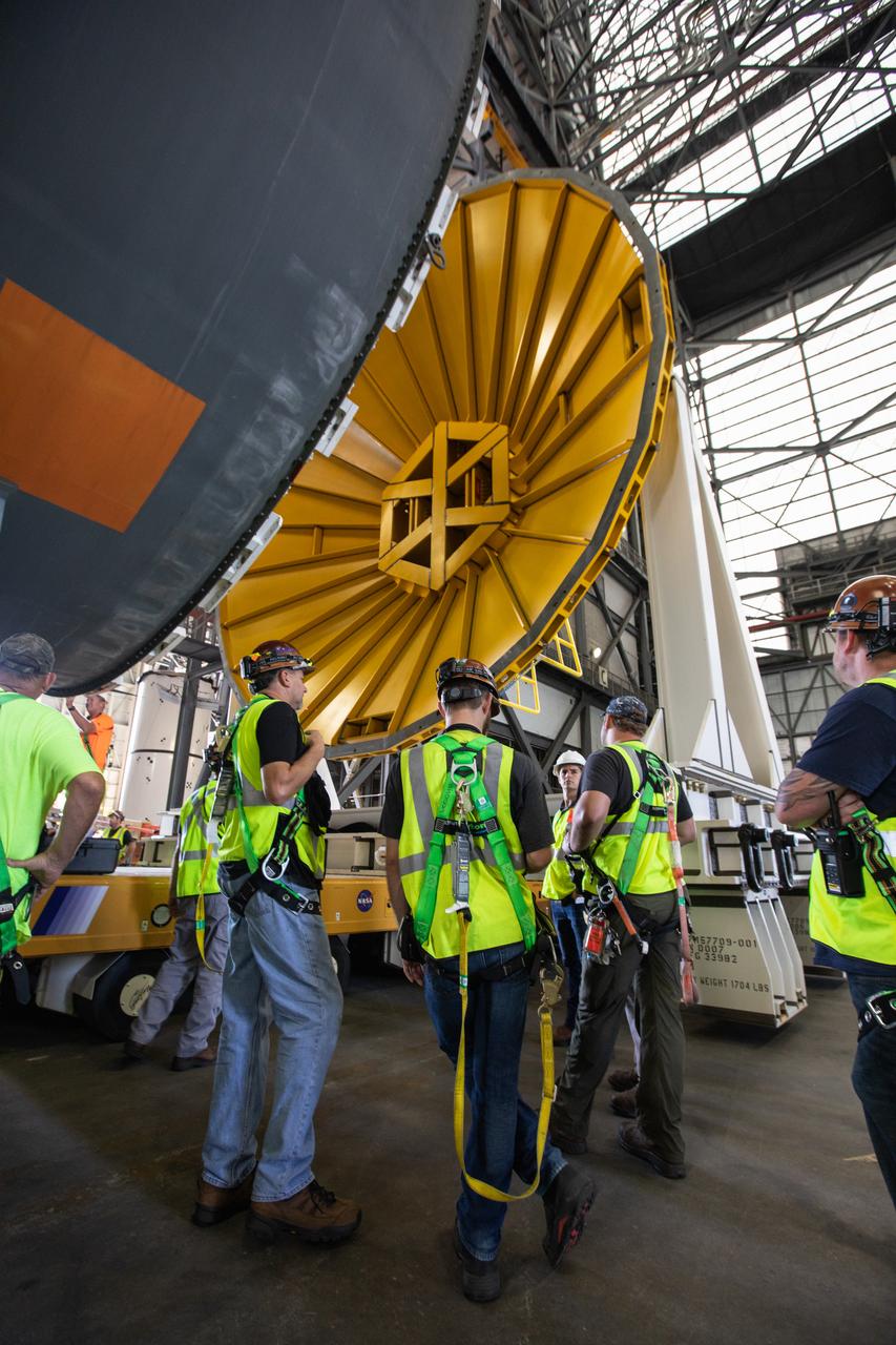Inside the Vehicle Assembly Building at NASA’s Kennedy Space Center in Florida, NASA and Jacobs TOSC workers monitor the progress as a cover, called the spider, is attached to the top of the Space Launch System (SLS) Core Stage pathfinder on Oct. 3, 2019. With the spider secured in place, a crane will be attached to it to lift the pathfinder into the vertical position. The 212-foot-long core stage pathfinder arrived in NASA's Pegasus Barge at Kennedy’s Launch Complex 39 turn basin wharf on Sept. 27, 2019. The Pegasus Barge made its first delivery to Kennedy in support of the agency's Artemis missions. The upgraded 310-foot-long barge arrived, ferrying the SLS core stage pathfinder, a full-scale mock-up of the rocket's core stage. It will be used by Exploration Ground Systems and its contractor, Jacobs, to practice offloading, moving and stacking maneuvers, using important ground support equipment to train employees and certify all the equipment works properly. The pathfinder will stay at Kennedy for approximately one month before trekking back to NASA's Michoud Assembly Facility in Louisiana.