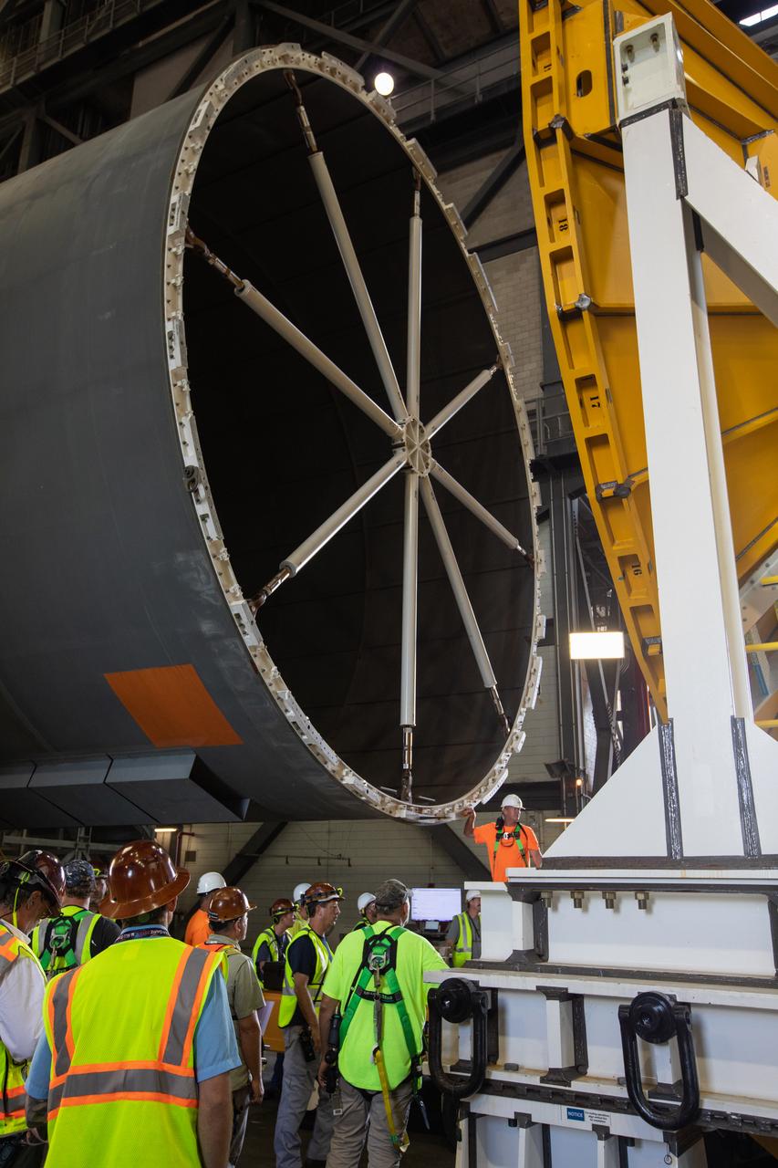 Inside the Vehicle Assembly Building at NASA’s Kennedy Space Center in Florida, NASA and Jacobs TOSC workers monitor the progress as a cover, called the spider, is attached to the top of the Space Launch System (SLS) Core Stage pathfinder on Oct. 3, 2019. With the spider secured in place, a crane will be attached to it to lift the pathfinder into the vertical position. The 212-foot-long core stage pathfinder arrived in NASA's Pegasus Barge at Kennedy’s Launch Complex 39 turn basin wharf on Sept. 27, 2019. The Pegasus Barge made its first delivery to Kennedy in support of the agency's Artemis missions. The upgraded 310-foot-long barge arrived, ferrying the SLS core stage pathfinder, a full-scale mock-up of the rocket's core stage. It will be used by Exploration Ground Systems and its contractor, Jacobs, to practice offloading, moving and stacking maneuvers, using important ground support equipment to train employees and certify all the equipment works properly. The pathfinder will stay at Kennedy for approximately one month before trekking back to NASA's Michoud Assembly Facility in Louisiana.