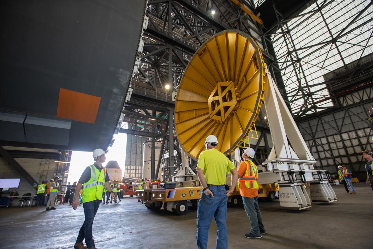 Inside the Vehicle Assembly Building at NASA’s Kennedy Space Center in Florida, NASA and Jacobs TOSC workers monitor the progress as a cover, called the spider, is attached to the top of the Space Launch System (SLS) Core Stage pathfinder on Oct. 3, 2019. With the spider secured in place, a crane will be attached to it to lift the pathfinder into the vertical position. The 212-foot-long core stage pathfinder arrived in NASA's Pegasus Barge at Kennedy’s Launch Complex 39 turn basin wharf on Sept. 27, 2019. The Pegasus Barge made its first delivery to Kennedy in support of the agency's Artemis missions. The upgraded 310-foot-long barge arrived, ferrying the SLS core stage pathfinder, a full-scale mock-up of the rocket's core stage. It will be used by Exploration Ground Systems and its contractor, Jacobs, to practice offloading, moving and stacking maneuvers, using important ground support equipment to train employees and certify all the equipment works properly. The pathfinder will stay at Kennedy for approximately one month before trekking back to NASA's Michoud Assembly Facility in Louisiana.