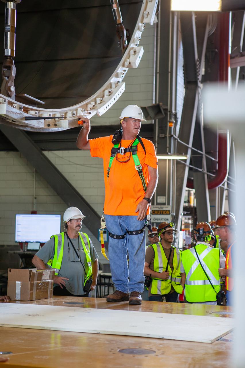 Inside the Vehicle Assembly Building at NASA’s Kennedy Space Center in Florida, NASA and Jacobs TOSC workers monitor the progress as a cover, called the spider, is attached to the top of the Space Launch System (SLS) Core Stage pathfinder on Oct. 3, 2019. With the spider secured in place, a crane will be attached to it to lift the pathfinder into the vertical position. The 212-foot-long core stage pathfinder arrived in NASA's Pegasus Barge at Kennedy’s Launch Complex 39 turn basin wharf on Sept. 27, 2019. The Pegasus Barge made its first delivery to Kennedy in support of the agency's Artemis missions. The upgraded 310-foot-long barge arrived, ferrying the SLS core stage pathfinder, a full-scale mock-up of the rocket's core stage. It will be used by Exploration Ground Systems and its contractor, Jacobs, to practice offloading, moving and stacking maneuvers, using important ground support equipment to train employees and certify all the equipment works properly. The pathfinder will stay at Kennedy for approximately one month before trekking back to NASA's Michoud Assembly Facility in Louisiana.