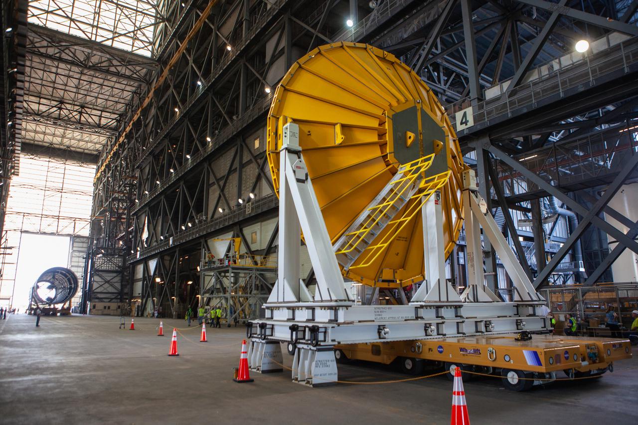 Preparations are underway to move the Space Launch System Core Stage pathfinder to the north end of the transfer aisle inside the Vehicle Assembly Building at NASA’s Kennedy Space Center in Florida on Oct. 3, 2019. A cover, called a spider, in view in the foreground, will be attached to the top of the pathfinder. With the spider secured in place, a crane will be attached to it to lift the pathfinder into the vertical position. The 212-foot-long core stage pathfinder arrived in NASA's Pegasus Barge at Kennedy’s Launch Complex 39 turn basin wharf on Sept. 27, 2019. The Pegasus Barge made its first delivery to Kennedy in support of the agency's Artemis missions. The upgraded 310-foot-long barge arrived, ferrying the SLS core stage pathfinder, a full-scale mock-up of the rocket's core stage. It will be used by Exploration Ground Systems and its contractor, Jacobs, to practice offloading, moving and stacking maneuvers, using important ground support equipment to train employees and certify all the equipment works properly. The pathfinder will stay at Kennedy for approximately one month before trekking back to NASA's Michoud Assembly Facility in Louisiana.
