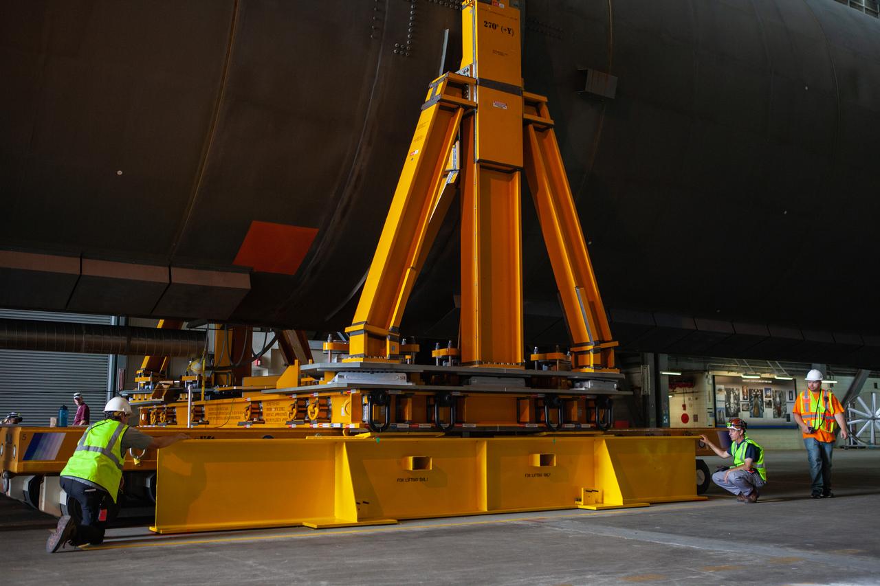 Preparations are underway to move the Space Launch System Core Stage pathfinder to the north end of the transfer aisle inside the Vehicle Assembly Building at NASA’s Kennedy Space Center in Florida on Oct. 3, 2019. A cover, called a spider, will be attached to the top of the pathfinder. With the spider secured in place, a crane will be attached to it to lift the pathfinder into the vertical position. The 212-foot-long core stage pathfinder arrived in NASA's Pegasus Barge at Kennedy’s Launch Complex 39 turn basin wharf on Sept. 27, 2019. The Pegasus Barge made its first delivery to Kennedy in support of the agency's Artemis missions. The upgraded 310-foot-long barge arrived, ferrying the SLS core stage pathfinder, a full-scale mock-up of the rocket's core stage. It will be used by Exploration Ground Systems and its contractor, Jacobs, to practice offloading, moving and stacking maneuvers, using important ground support equipment to train employees and certify all the equipment works properly. The pathfinder will stay at Kennedy for approximately one month before trekking back to NASA's Michoud Assembly Facility in Louisiana.