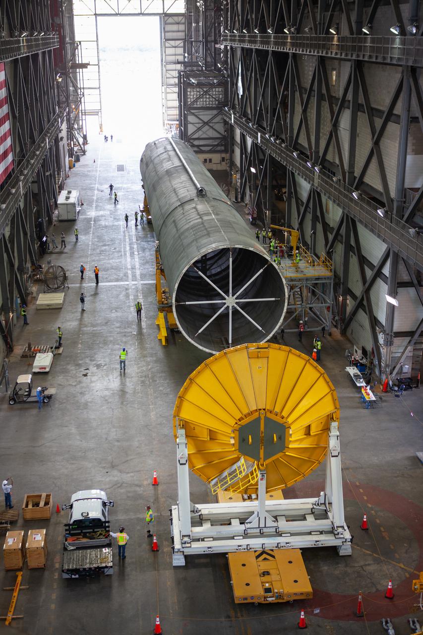 The Space Launch System Core Stage pathfinder has arrived at the north end of the transfer aisle inside the Vehicle Assembly Building at NASA’s Kennedy Space Center in Florida on Oct. 3, 2019. A cover, called a spider, in view in the foreground, will be attached to the top of the pathfinder. With the spider secured in place, a crane will be attached to it to lift the pathfinder into the vertical position. The 212-foot-long core stage pathfinder arrived in NASA's Pegasus Barge at Kennedy’s Launch Complex 39 turn basin wharf on Sept. 27, 2019. The Pegasus Barge made its first delivery to Kennedy in support of the agency's Artemis missions. The upgraded 310-foot-long barge arrived, ferrying the SLS core stage pathfinder, a full-scale mock-up of the rocket's core stage. It will be used by Exploration Ground Systems and its contractor, Jacobs, to practice offloading, moving and stacking maneuvers, using important ground support equipment to train employees and certify all the equipment works properly. The pathfinder will stay at Kennedy for approximately one month before trekking back to NASA's Michoud Assembly Facility in Louisiana.