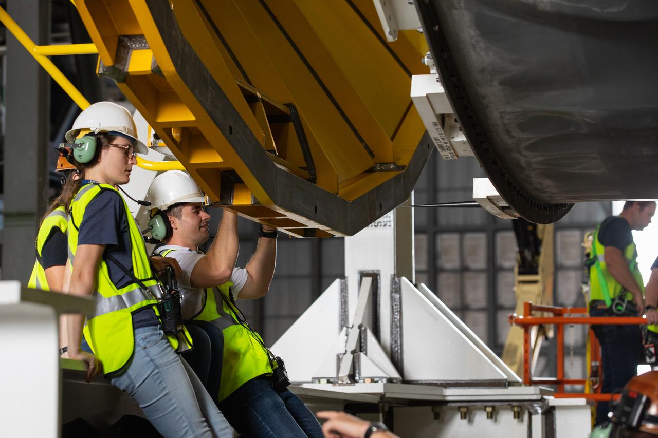 Inside the Vehicle Assembly Building at NASA’s Kennedy Space Center in Florida, operations are underway to attach a cover, called a spider, to the top of the Space Launch System (SLS) Core Stage pathfinder on Oct. 4, 2019. With the spider secured in place, a crane will be attached to it to lift the pathfinder into the vertical position. The 212-foot-long core stage pathfinder arrived on NASA's Pegasus Barge at Kennedy’s Launch Complex 39 turn basin wharf on Sept. 27, 2019. The Pegasus Barge made its first delivery to Kennedy in support of the agency's Artemis missions. The upgraded 310-foot-long barge arrived, ferrying the SLS core stage pathfinder, a full-scale mock-up of the rocket's core stage. It is being used by Exploration Ground Systems and its contractor, Jacobs, to practice offloading, moving and stacking maneuvers, using important ground support equipment to train employees and certify all the equipment works properly. The pathfinder will stay at Kennedy for approximately one month before trekking back to NASA's Michoud Assembly Facility in Louisiana.