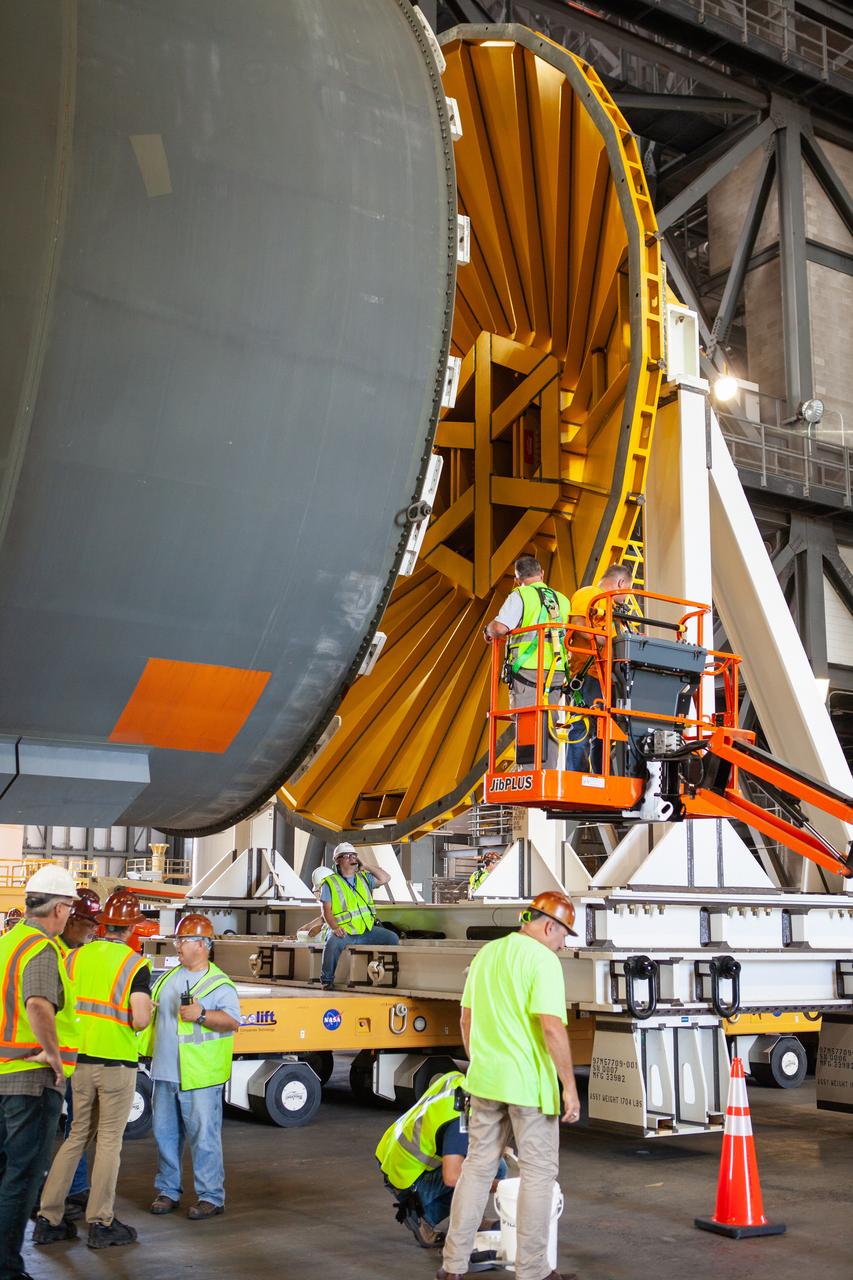 Inside the Vehicle Assembly Building at NASA’s Kennedy Space Center in Florida, operations are underway to attach a cover, called a spider, to the top of the Space Launch System (SLS) Core Stage pathfinder on Oct. 4, 2019. With the spider secured in place, a crane will be attached to it to lift the pathfinder into the vertical position. The 212-foot-long core stage pathfinder arrived on NASA's Pegasus Barge at Kennedy’s Launch Complex 39 turn basin wharf on Sept. 27, 2019. The Pegasus Barge made its first delivery to Kennedy in support of the agency's Artemis missions. The upgraded 310-foot-long barge arrived, ferrying the SLS core stage pathfinder, a full-scale mock-up of the rocket's core stage. It will be used by Exploration Ground Systems and its contractor, Jacobs, to practice offloading, moving and stacking maneuvers, using important ground support equipment to train employees and certify all the equipment works properly. The pathfinder will stay at Kennedy for approximately one month before trekking back to NASA's Michoud Assembly Facility in Louisiana.