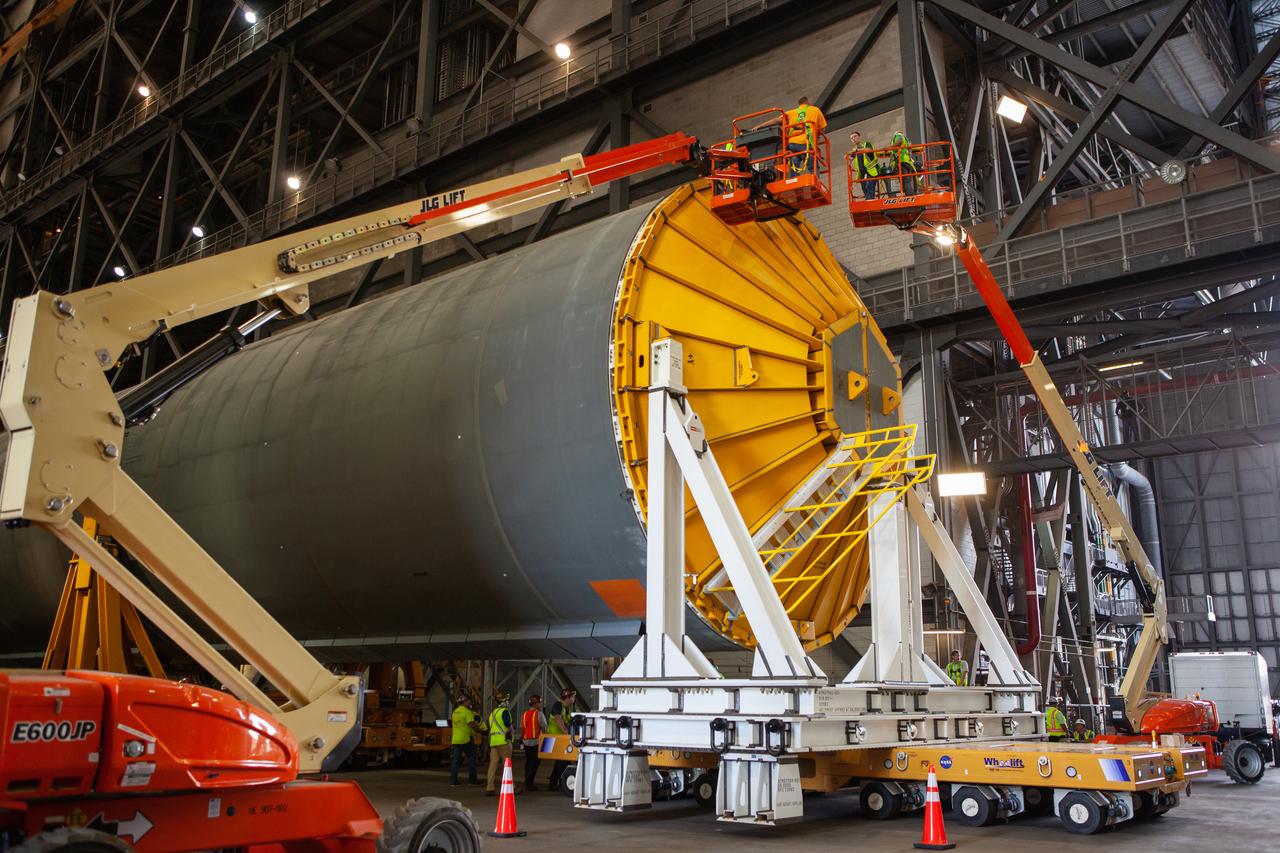 Inside the Vehicle Assembly Building at NASA’s Kennedy Space Center in Florida, a cover, called a spider, is attached to the top of the Space Launch System (SLS) Core Stage pathfinder on Oct. 4, 2019. With the spider secured in place, a crane will be attached to it to lift the pathfinder into the vertical position. The 212-foot-long core stage pathfinder arrived on NASA's Pegasus Barge at Kennedy’s Launch Complex 39 turn basin wharf on Sept. 27, 2019. The Pegasus Barge made its first delivery to Kennedy in support of the agency's Artemis missions. The upgraded 310-foot-long barge arrived, ferrying the SLS core stage pathfinder, a full-scale mock-up of the rocket's core stage. It will be used by Exploration Ground Systems and its contractor, Jacobs, to practice offloading, moving and stacking maneuvers, using important ground support equipment to train employees and certify all the equipment works properly. The pathfinder will stay at Kennedy for approximately one month before trekking back to NASA's Michoud Assembly Facility in Louisiana.