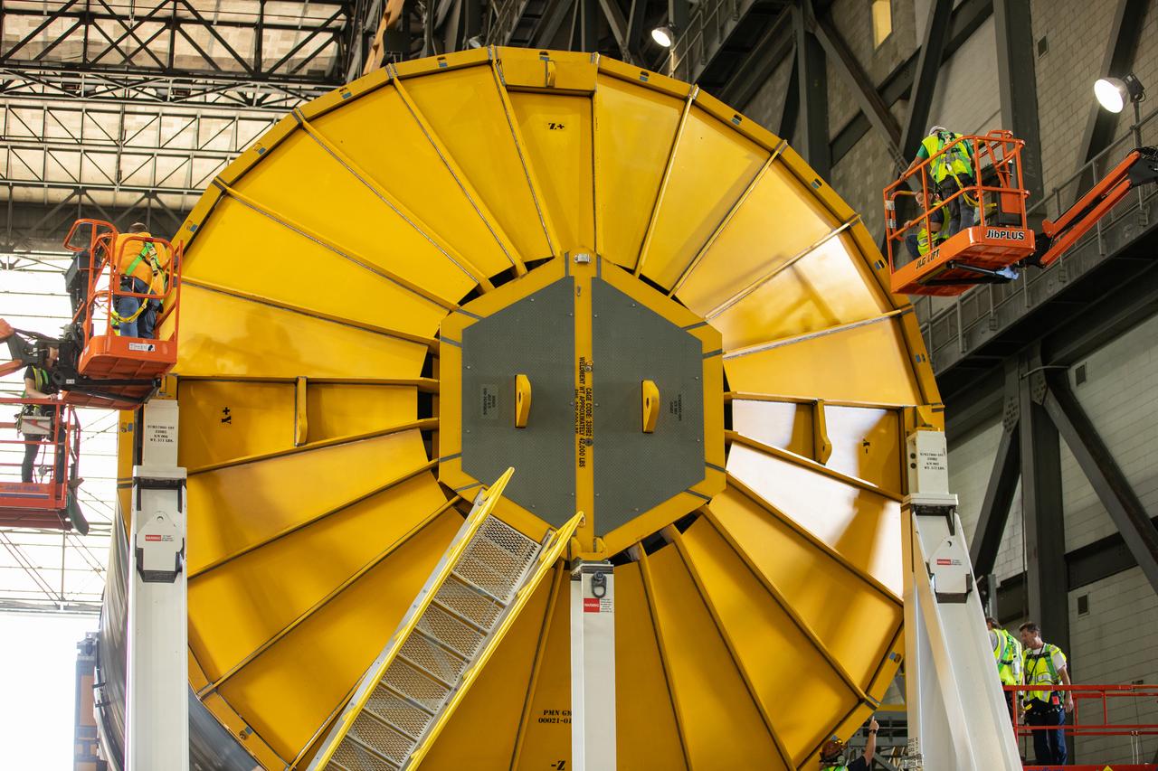 Inside the Vehicle Assembly Building at NASA’s Kennedy Space Center in Florida, a cover, called a spider, is attached to the top of the Space Launch System (SLS) Core Stage pathfinder on Oct. 4, 2019. With the spider secured in place, a crane will be attached to it to lift the pathfinder into the vertical position. The 212-foot-long core stage pathfinder arrived on NASA's Pegasus Barge at Kennedy’s Launch Complex 39 turn basin wharf on Sept. 27, 2019. The Pegasus Barge made its first delivery to Kennedy in support of the agency's Artemis missions. The upgraded 310-foot-long barge arrived, ferrying the SLS core stage pathfinder, a full-scale mock-up of the rocket's core stage. It will be used by Exploration Ground Systems and its contractor, Jacobs, to practice offloading, moving and stacking maneuvers, using important ground support equipment to train employees and certify all the equipment works properly. The pathfinder will stay at Kennedy for approximately one month before trekking back to NASA's Michoud Assembly Facility in Louisiana.