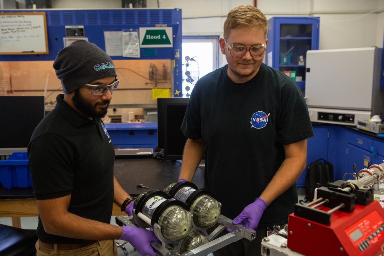 Team members Malay Shah, left, and Evan Bell assemble the flight hardware for NASA’s Orbital Syngas Commodity Augmentation Reactor, or OSCAR, on Oct. 10, 2019, in the Space Station Processing Facility at the agency’s Kennedy Space Center in Florida. OSCAR is an Early Career Initiative project at the spaceport that studies technology to convert trash and human waste into useful gasses such as methane, hydrogen and carbon dioxide. By processing small pieces of trash in a high-temperature reactor, OSCAR is advancing new and innovative technology for managing waste in space. A prototype has been developed, and the team is in the process of constructing a new rig for a suborbital flight test.