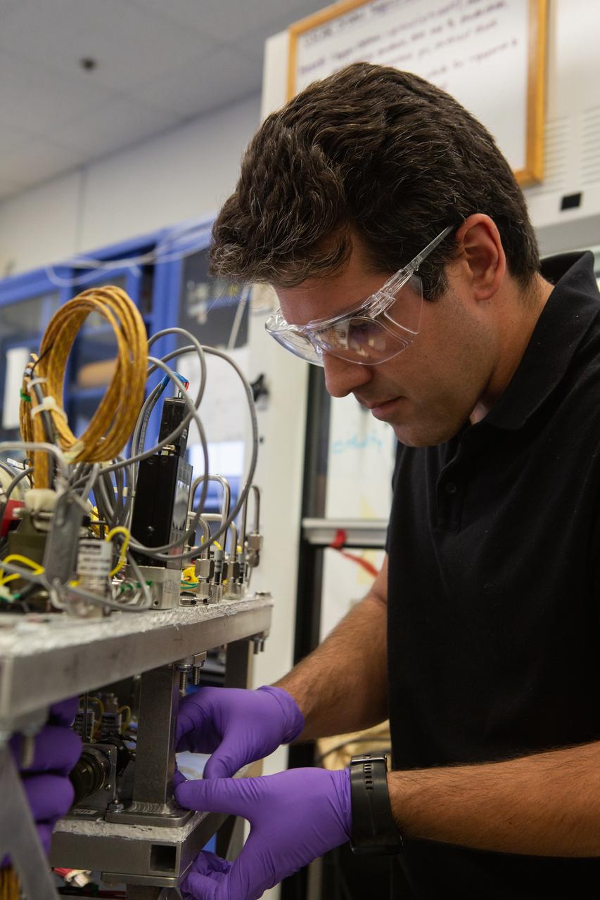 Jaime Toro assembles the flight hardware for NASA’s Orbital Syngas Commodity Augmentation Reactor, or OSCAR, on Oct. 10, 2019, in the Space Station Processing Facility at the agency’s Kennedy Space Center in Florida. OSCAR is an Early Career Initiative project at the spaceport that studies technology to convert trash and human waste into useful gasses such as methane, hydrogen and carbon dioxide. By processing small pieces of trash in a high-temperature reactor, OSCAR is advancing new and innovative technology for managing waste in space. A prototype has been developed, and the team is in the process of constructing a new rig for a suborbital flight test.