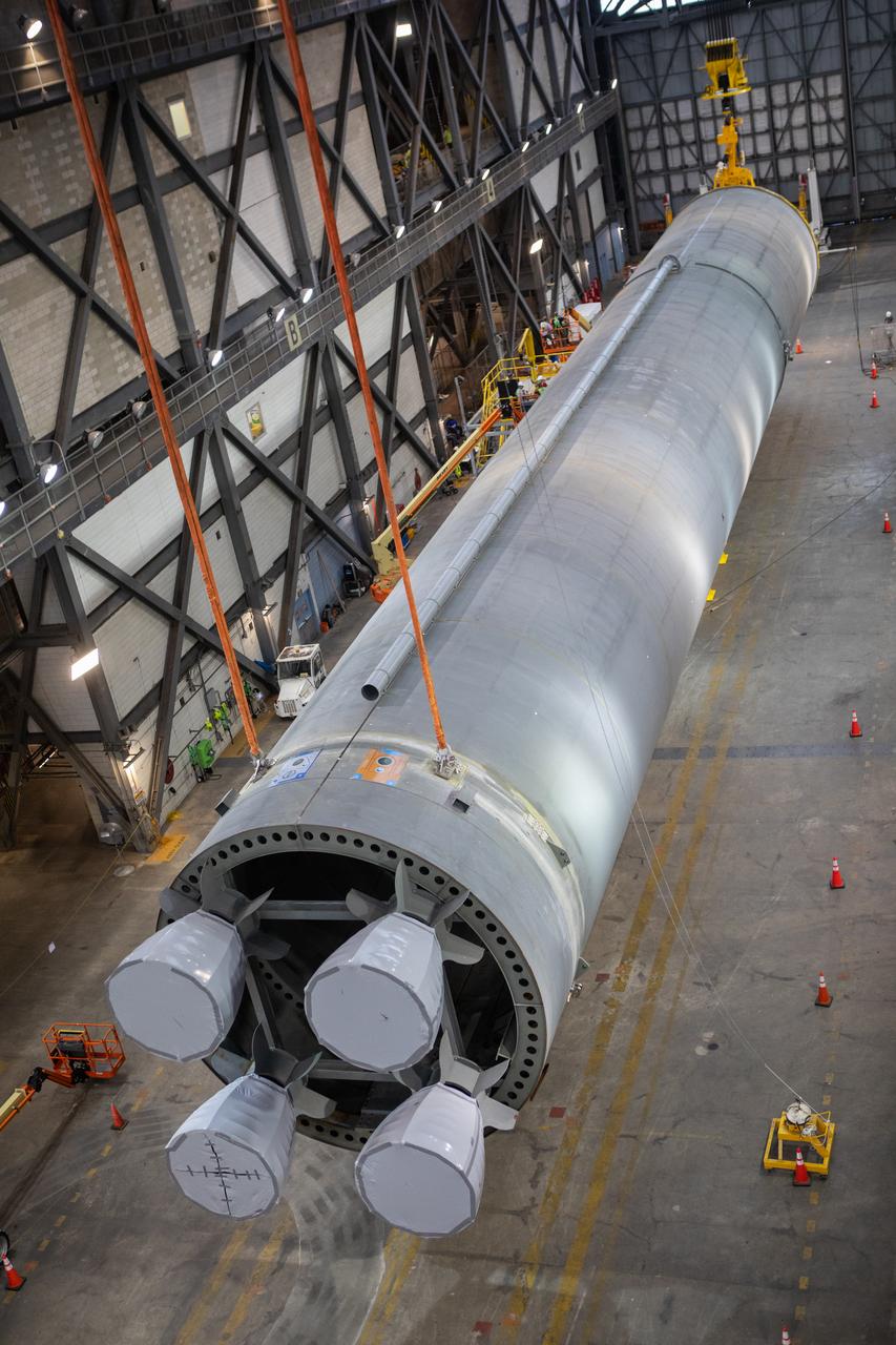 Inside the Vehicle Assembly Building at NASA’s Kennedy Space Center in Florida, two cranes are used to lift the Space Launch System (SLS) Core Stage pathfinder horizontally above the transfer aisle on Oct. 15, 2019. The 212-foot-long core stage pathfinder arrived on NASA's Pegasus Barge at Kennedy’s Launch Complex 39 turn basin wharf on Sept. 27, 2019. The Pegasus Barge made its first delivery to Kennedy in support of the agency's Artemis missions. The pathfinder is being used by Exploration Ground Systems and its contractor, Jacobs, to practice offloading, moving and stacking maneuvers, using important ground support equipment to train employees and certify all the equipment works properly. The pathfinder will stay at Kennedy through at least the month of October before trekking back to NASA's Michoud Assembly Facility in Louisiana.