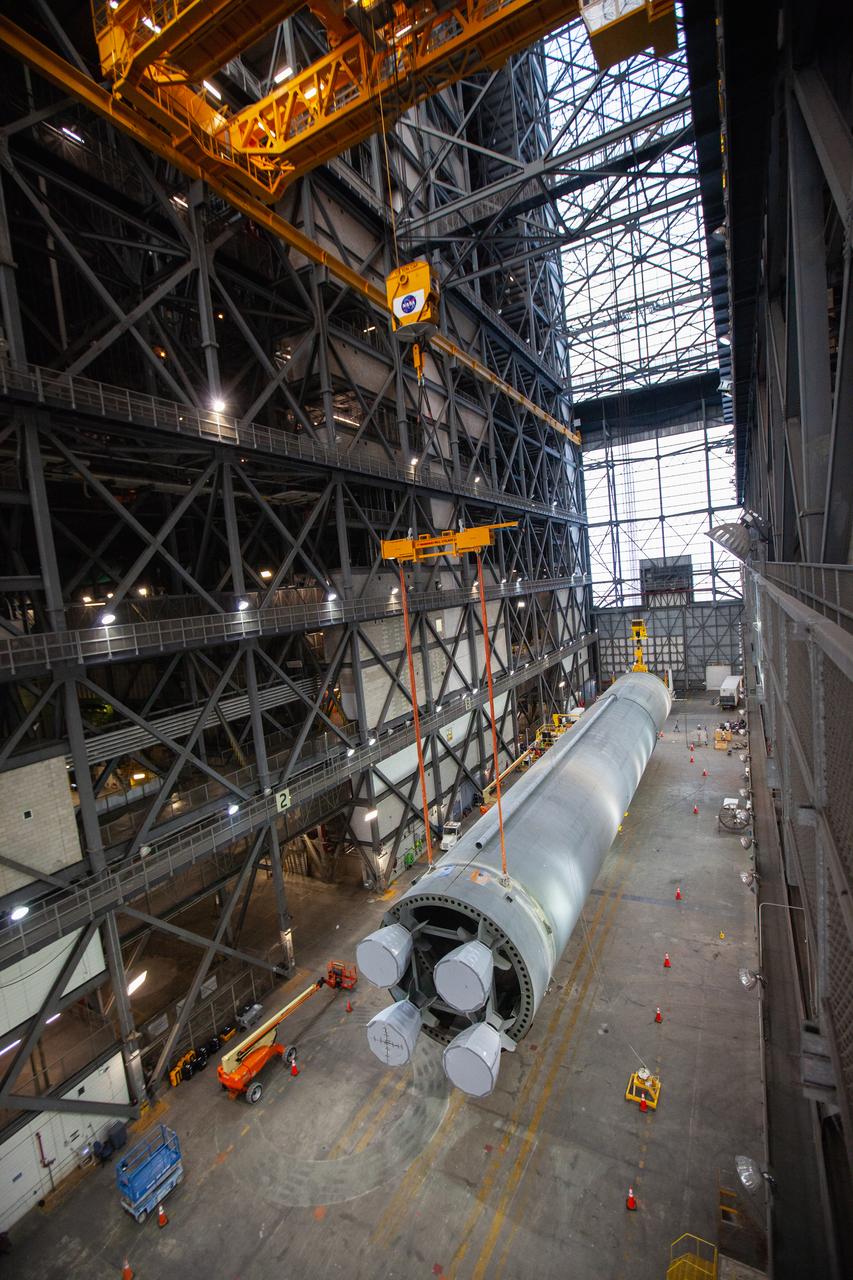 Inside the Vehicle Assembly Building at NASA’s Kennedy Space Center in Florida, the Space Launch System (SLS) Core Stage pathfinder is lifted horizontally in the transfer aisle on Oct. 15, 2019. The 212-foot-long core stage pathfinder arrived on NASA's Pegasus Barge at Kennedy’s Launch Complex 39 turn basin wharf on Sept. 27, 2019. The Pegasus Barge made its first delivery to Kennedy in support of the agency's Artemis missions. The pathfinder is being used by Exploration Ground Systems and its contractor, Jacobs, to practice offloading, moving and stacking maneuvers, using important ground support equipment to train employees and certify all the equipment works properly. The pathfinder will stay at Kennedy through at least the month of October before trekking back to NASA's Michoud Assembly Facility in Louisiana.