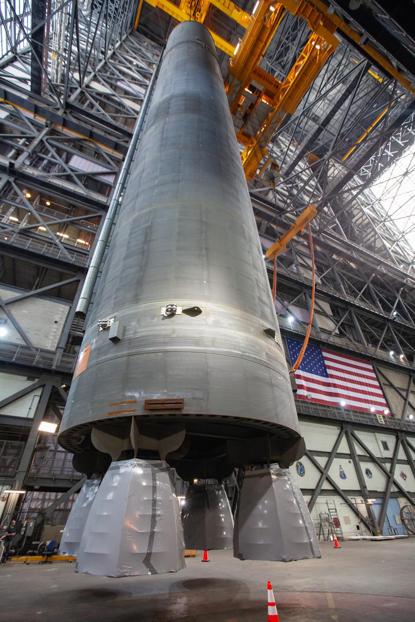 Inside the Vehicle Assembly Building at NASA’s Kennedy Space Center in Florida, a crane is used to lift the Space Launch System (SLS) Core Stage pathfinder into the vertical position in the transfer aisle on Oct. 15, 2019. The 212-foot-long core stage pathfinder arrived on NASA's Pegasus Barge at Kennedy’s Launch Complex 39 turn basin wharf on Sept. 27, 2019. The Pegasus Barge made its first delivery to Kennedy in support of the agency's Artemis missions. The pathfinder is being used by Exploration Ground Systems and its contractor, Jacobs, to practice offloading, moving and stacking maneuvers, using important ground support equipment to train employees and certify all the equipment works properly. The pathfinder will stay at Kennedy through at least the month of October before trekking back to NASA's Michoud Assembly Facility in Louisiana.