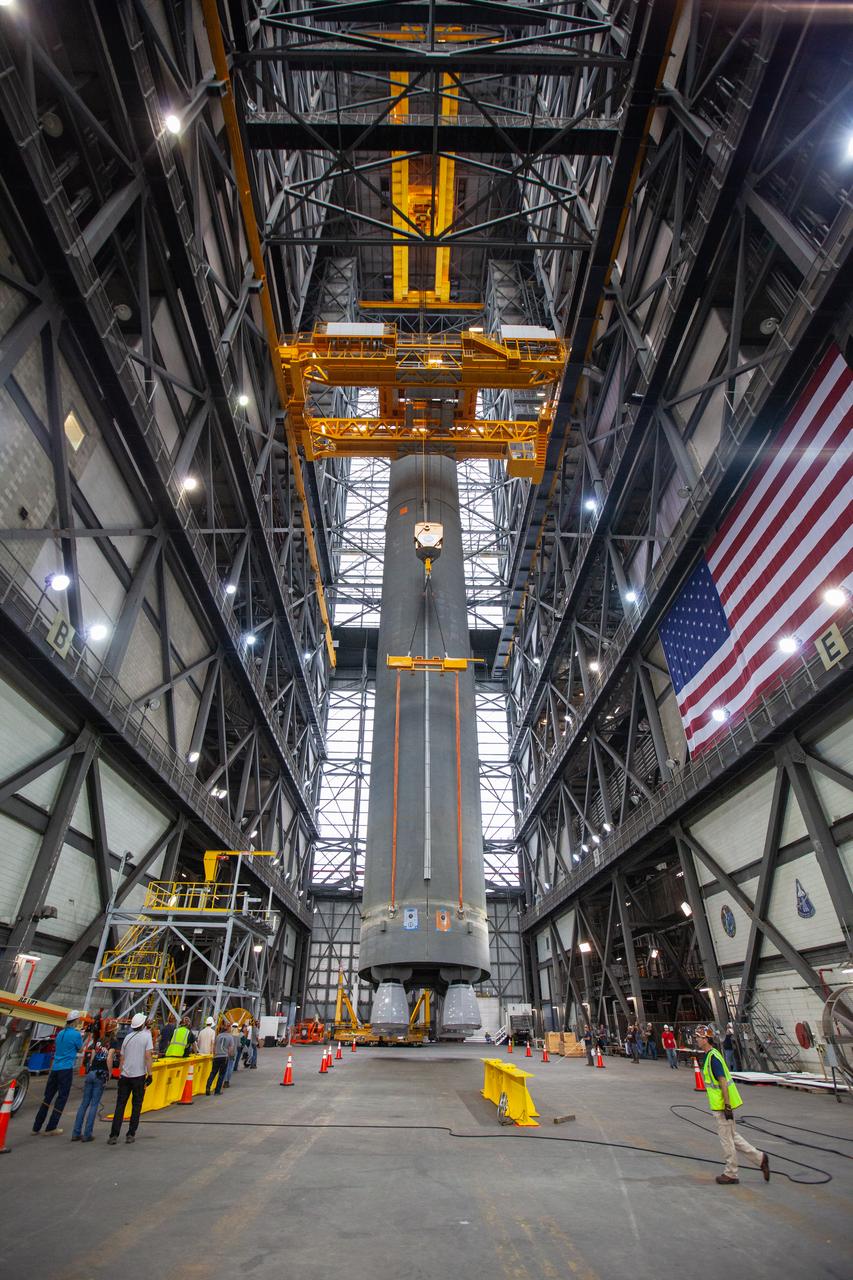 Inside the Vehicle Assembly Building at NASA’s Kennedy Space Center in Florida, two cranes are used to lift the Space Launch System (SLS) Core Stage pathfinder into the vertical position in the transfer aisle on Oct. 15, 2019. The 212-foot-long core stage pathfinder arrived on NASA's Pegasus Barge at Kennedy’s Launch Complex 39 turn basin wharf on Sept. 27, 2019. The Pegasus Barge made its first delivery to Kennedy in support of the agency's Artemis missions. The pathfinder is being used by Exploration Ground Systems and its contractor, Jacobs, to practice offloading, moving and stacking maneuvers, using important ground support equipment to train employees and certify all the equipment works properly. The pathfinder will stay at Kennedy through at least the month of October before trekking back to NASA's Michoud Assembly Facility in Louisiana.
