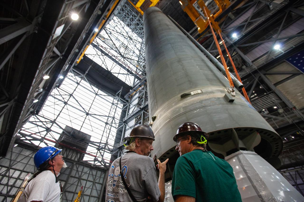 Inside the Vehicle Assembly Building at NASA’s Kennedy Space Center in Florida, NASA and contractor Jacobs workers watch as two cranes are used to lift the Space Launch System (SLS) Core Stage pathfinder into the vertical position in the transfer aisle on Oct. 15, 2019. The 212-foot-long core stage pathfinder arrived on NASA's Pegasus Barge at Kennedy’s Launch Complex 39 turn basin wharf on Sept. 27, 2019. The Pegasus Barge made its first delivery to Kennedy in support of the agency's Artemis missions. The pathfinder is being used by Exploration Ground Systems and its contractor, Jacobs, to practice offloading, moving and stacking maneuvers, using important ground support equipment to train employees and certify all the equipment works properly. The pathfinder will stay at Kennedy through at least the month of October before trekking back to NASA's Michoud Assembly Facility in Louisiana.