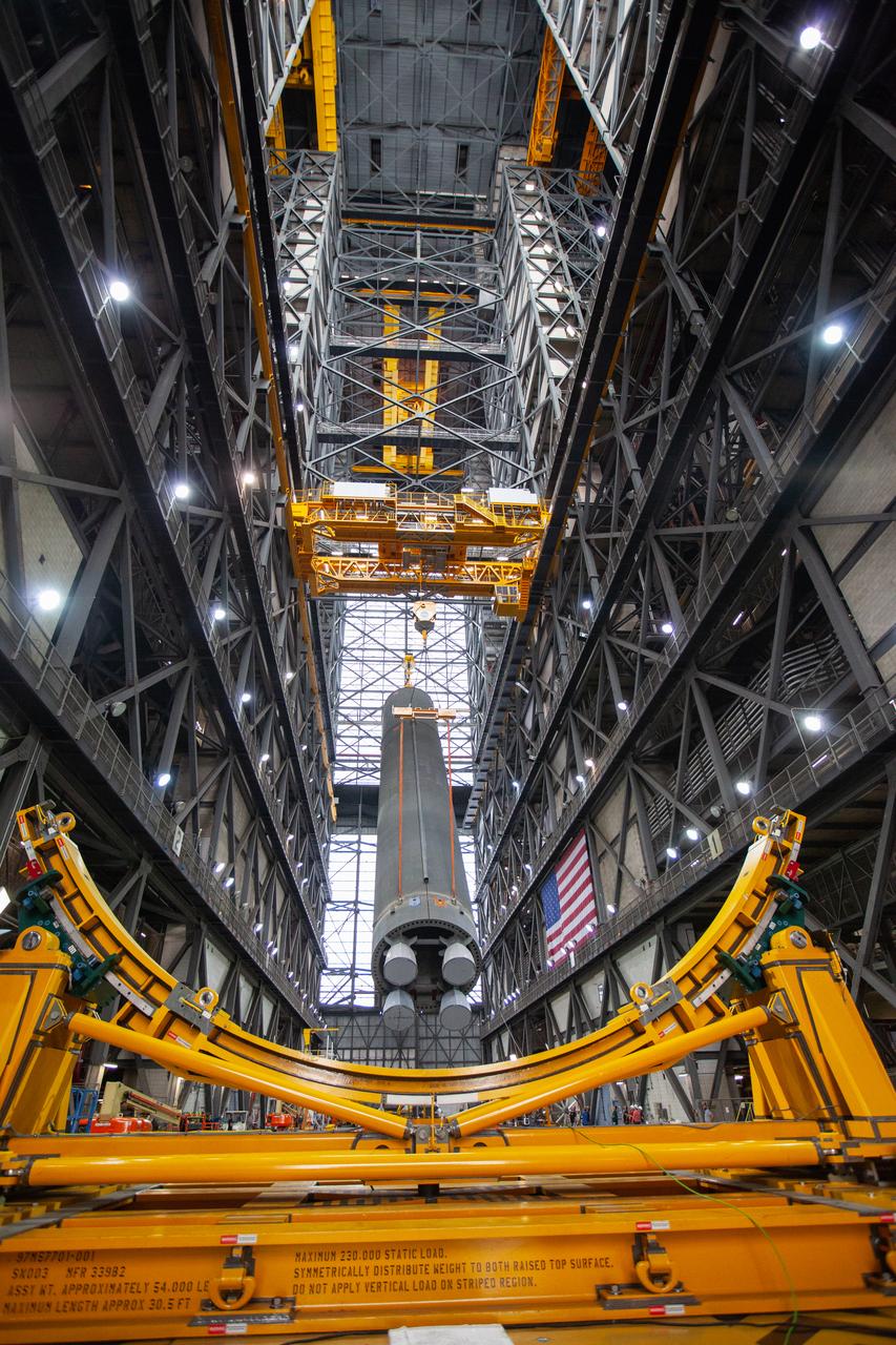 Inside the Vehicle Assembly Building at NASA’s Kennedy Space Center in Florida, two cranes are used to lift the Space Launch System (SLS) Core Stage pathfinder into the vertical position in the transfer aisle on Oct. 15, 2019. The 212-foot-long core stage pathfinder arrived on NASA's Pegasus Barge at Kennedy’s Launch Complex 39 turn basin wharf on Sept. 27, 2019. The Pegasus Barge made its first delivery to Kennedy in support of the agency's Artemis missions. The pathfinder is being used by Exploration Ground Systems and its contractor, Jacobs, to practice offloading, moving and stacking maneuvers, using important ground support equipment to train employees and certify all the equipment works properly. The pathfinder will stay at Kennedy through at least the month of October before trekking back to NASA's Michoud Assembly Facility in Louisiana.