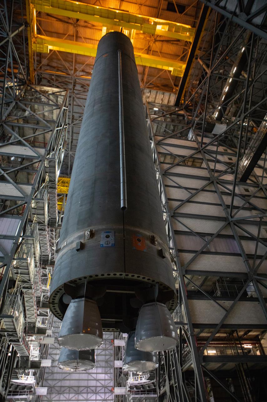 Inside the Vehicle Assembly Building at NASA’s Kennedy Space Center in Florida, the Space Launch System (SLS) Core Stage pathfinder is lifted in the vertical position in the transfer aisle on Oct. 16, 2019. The pathfinder will be lifted up to the 16th level and lowered into High Bay 3. The 212-foot-long core stage pathfinder arrived on NASA's Pegasus Barge at Kennedy’s Launch Complex 39 turn basin wharf on Sept. 27, 2019. The Pegasus Barge made its first delivery to Kennedy in support of the agency's Artemis missions. The pathfinder is being used by Exploration Ground Systems and its contractor, Jacobs, to practice offloading, moving and stacking maneuvers, using important ground support equipment to train employees and certify all the equipment works properly. The pathfinder will stay at Kennedy through at least the month of October before trekking back to NASA's Michoud Assembly Facility in Louisiana.