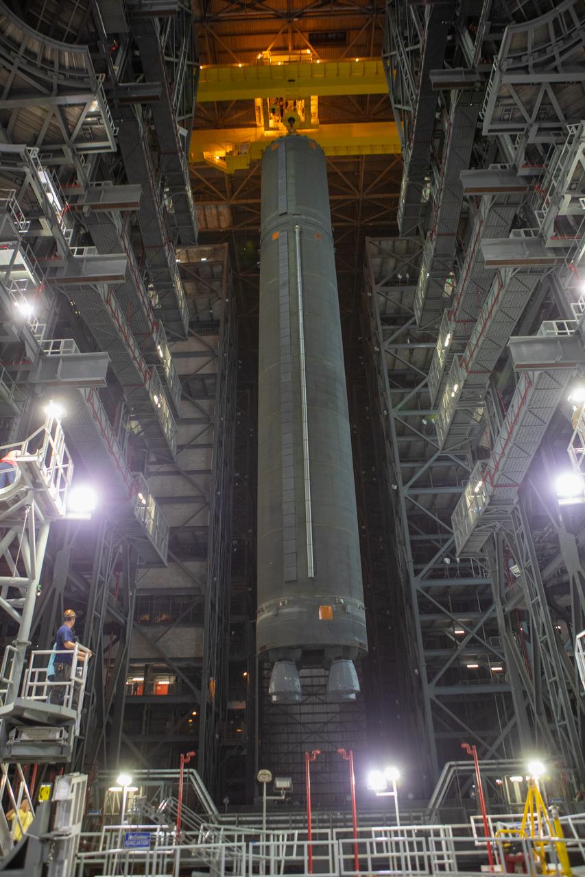 Inside the Vehicle Assembly Building at NASA’s Kennedy Space Center in Florida, a crane lowers the Space Launch System (SLS) Core Stage pathfinder into High Bay 3 on Oct. 16, 2019. The 212-foot-long core stage pathfinder arrived on NASA's Pegasus Barge at Kennedy’s Launch Complex 39 turn basin wharf on Sept. 27, 2019. The Pegasus Barge made its first delivery to Kennedy in support of the agency's Artemis missions. The pathfinder is being used by Exploration Ground Systems and its contractor, Jacobs, to practice offloading, moving and stacking maneuvers, using important ground support equipment to train employees and certify all the equipment works properly. The pathfinder will stay at Kennedy through at least the month of October before trekking back to NASA's Michoud Assembly Facility in Louisiana.