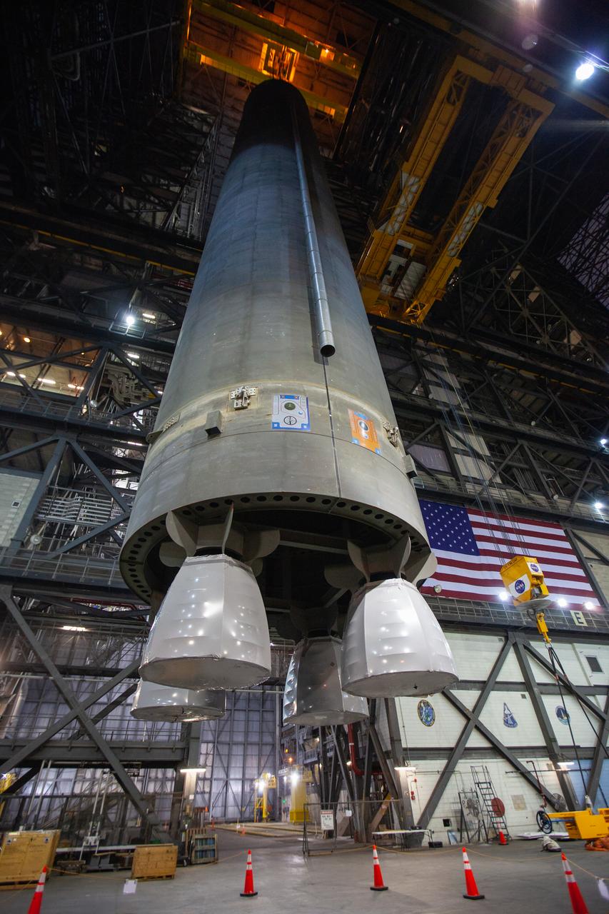 Inside the Vehicle Assembly Building at NASA’s Kennedy Space Center in Florida, a crane is used to lift the Space Launch System (SLS) Core Stage pathfinder up in the transfer aisle on Oct. 16, 2019. The pathfinder will be lifted up to the 16th level and lowered into High Bay 3. The 212-foot-long core stage pathfinder arrived on NASA's Pegasus Barge at Kennedy’s Launch Complex 39 turn basin wharf on Sept. 27, 2019. The Pegasus Barge made its first delivery to Kennedy in support of the agency's Artemis missions. The pathfinder is being used by Exploration Ground Systems and its contractor, Jacobs, to practice offloading, moving and stacking maneuvers, using important ground support equipment to train employees and certify all the equipment works properly. The pathfinder will stay at Kennedy through at least the month of October before trekking back to NASA's Michoud Assembly Facility in Louisiana.