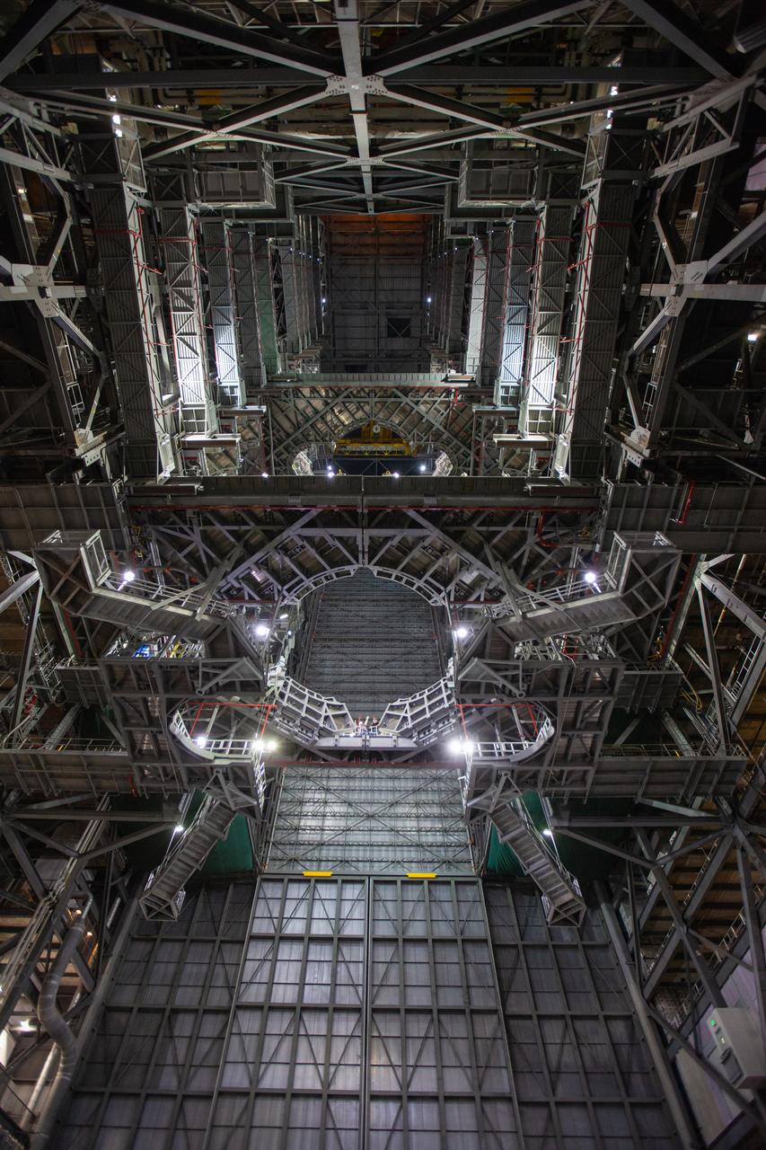 A view looking up in High Bay 3 inside the Vehicle Assembly Building at NASA’s Kennedy Space Center in Florida. The Space Launch System (SLS) Core Stage pathfinder will be lowered into the bay after being lifted high up in the vertical position in the transfer aisle on Oct. 16, 2019. The 212-foot-long core stage pathfinder arrived on NASA's Pegasus Barge at Kennedy’s Launch Complex 39 turn basin wharf on Sept. 27, 2019. The Pegasus Barge made its first delivery to Kennedy in support of the agency's Artemis missions. The pathfinder is being used by Exploration Ground Systems and its contractor, Jacobs, to practice offloading, moving and stacking maneuvers, using important ground support equipment to train employees and certify all the equipment works properly. The pathfinder will stay at Kennedy through at least the month of October before trekking back to NASA's Michoud Assembly Facility in Louisiana.