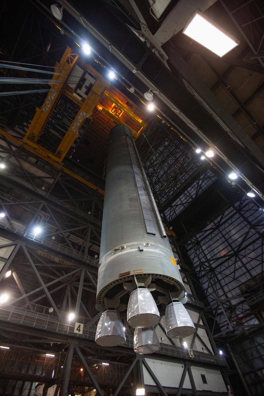 Inside the Vehicle Assembly Building at NASA’s Kennedy Space Center in Florida, a crane is used to lift the Space Launch System (SLS) Core Stage pathfinder high up in the transfer aisle on Oct. 16, 2019. The pathfinder will be lifted up to the 16th level and lowered into High Bay 3. The 212-foot-long core stage pathfinder arrived on NASA's Pegasus Barge at Kennedy’s Launch Complex 39 turn basin wharf on Sept. 27, 2019. The Pegasus Barge made its first delivery to Kennedy in support of the agency's Artemis missions. The pathfinder is being used by Exploration Ground Systems and its contractor, Jacobs, to practice offloading, moving and stacking maneuvers, using important ground support equipment to train employees and certify all the equipment works properly. The pathfinder will stay at Kennedy through at least the month of October before trekking back to NASA's Michoud Assembly Facility in Louisiana.
