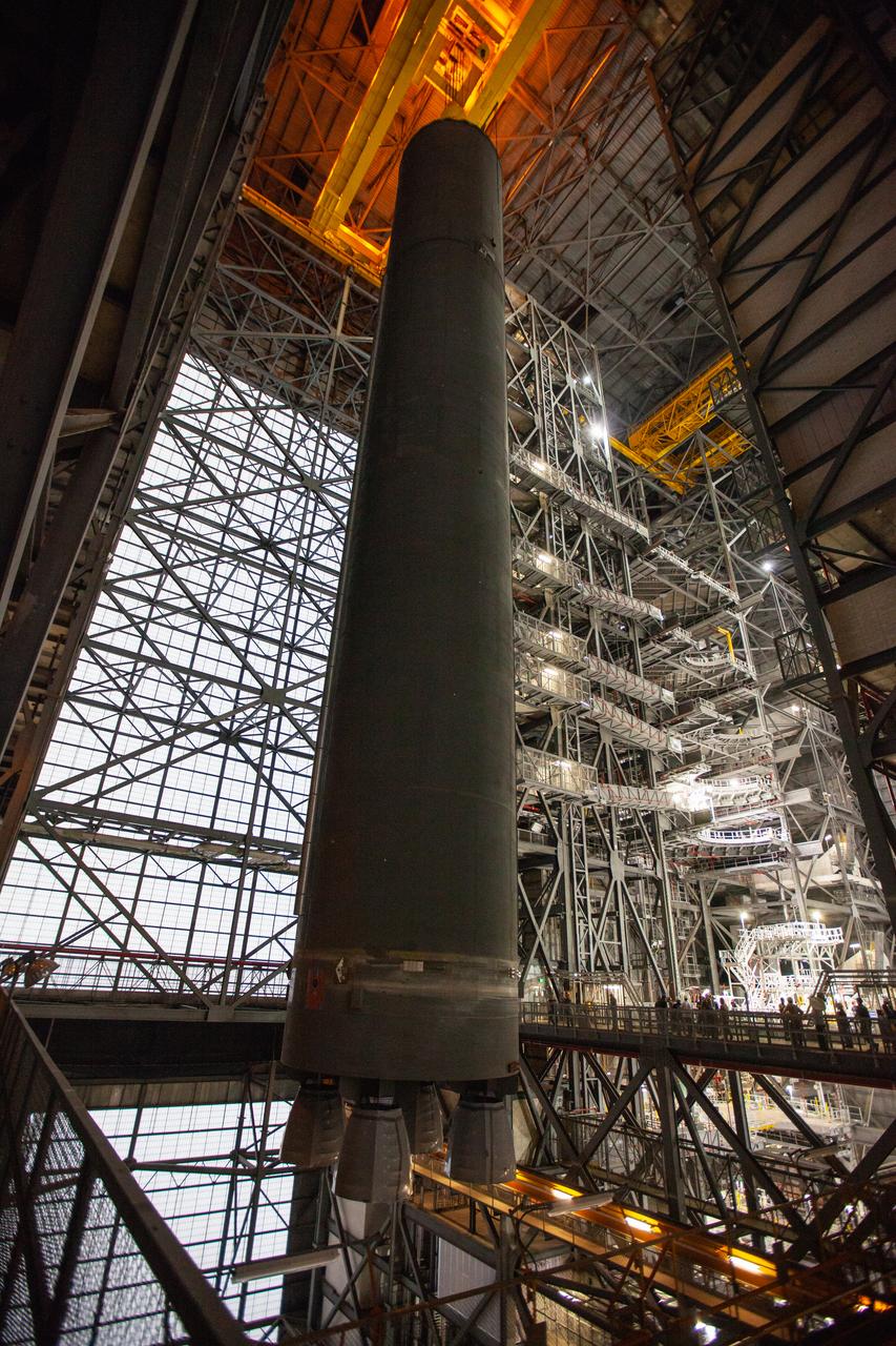 Inside the Vehicle Assembly Building at NASA’s Kennedy Space Center in Florida, a crane lifts the Space Launch System (SLS) Core Stage pathfinder high up in the transfer aisle on Oct. 16, 2019. The pathfinder will be lifted up to the 16th level and lowered into High Bay 3. The 212-foot-long core stage pathfinder arrived on NASA's Pegasus Barge at Kennedy’s Launch Complex 39 turn basin wharf on Sept. 27, 2019. The Pegasus Barge made its first delivery to Kennedy in support of the agency's Artemis missions. The pathfinder is being used by Exploration Ground Systems and its contractor, Jacobs, to practice offloading, moving and stacking maneuvers, using important ground support equipment to train employees and certify all the equipment works properly. The pathfinder will stay at Kennedy through at least the month of October before trekking back to NASA's Michoud Assembly Facility in Louisiana.