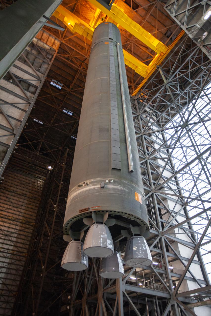 Inside the Vehicle Assembly Building at NASA’s Kennedy Space Center in Florida, a crane lifts the Space Launch System (SLS) Core Stage pathfinder high up in the transfer aisle on Oct. 16, 2019. The pathfinder will be lifted up to the 16th level and lowered into High Bay 3. The 212-foot-long core stage pathfinder arrived on NASA's Pegasus Barge at Kennedy’s Launch Complex 39 turn basin wharf on Sept. 27, 2019. The Pegasus Barge made its first delivery to Kennedy in support of the agency's Artemis missions. The pathfinder is being used by Exploration Ground Systems and its contractor, Jacobs, to practice offloading, moving and stacking maneuvers, using important ground support equipment to train employees and certify all the equipment works properly. The pathfinder will stay at Kennedy through at least the month of October before trekking back to NASA's Michoud Assembly Facility in Louisiana.