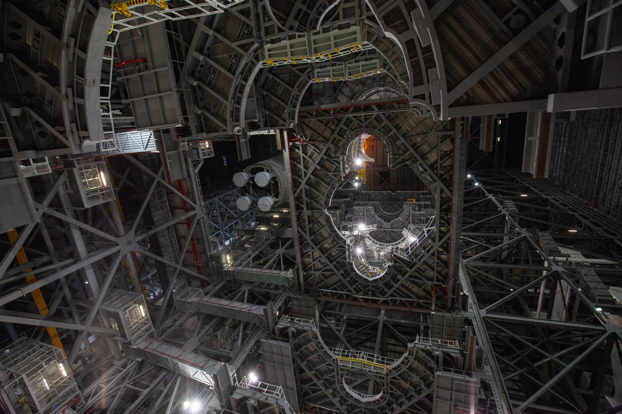 In this view looking up inside the Vehicle Assembly Building at NASA’s Kennedy Space Center in Florida, a crane lowers the Space Launch System (SLS) Core Stage pathfinder into High Bay 3 on Oct. 16, 2019. The 212-foot-long core stage pathfinder arrived on NASA's Pegasus Barge at Kennedy’s Launch Complex 39 turn basin wharf on Sept. 27, 2019. The Pegasus Barge made its first delivery to Kennedy in support of the agency's Artemis missions. The pathfinder is being used by Exploration Ground Systems and its contractor, Jacobs, to practice offloading, moving and stacking maneuvers, using important ground support equipment to train employees and certify all the equipment works properly. The pathfinder will stay at Kennedy through at least the month of October before trekking back to NASA's Michoud Assembly Facility in Louisiana.