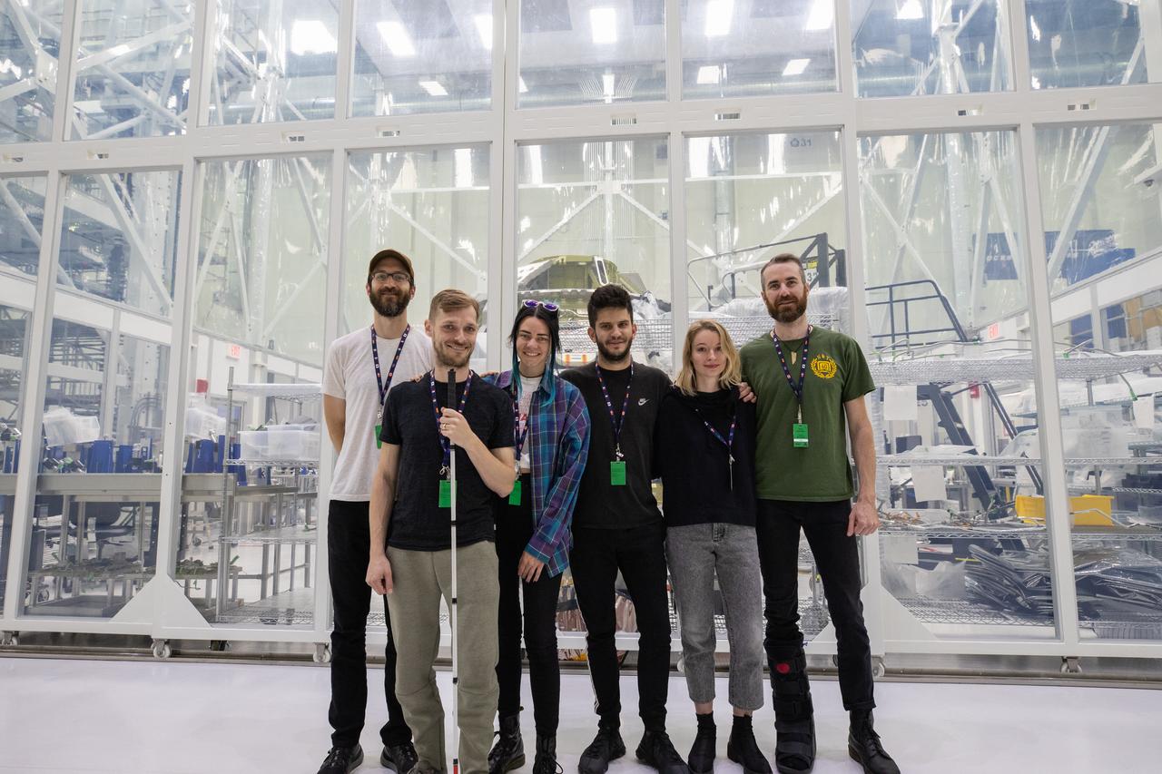 The rock band X Ambassadors is photographed in front of NASA’s Artemis II Orion crew module inside the Neil Armstrong Operations and Checkout (O&C) Building high bay at the agency’s Kennedy Space Center in Florida. X Ambassadors visited Kennedy on Oct. 21, 2019, and had the opportunity to tour areas around the multi-user spaceport such as the O&C, Launch Complex 39B and Swamp Works. The title of the band’s latest album, Orion, led them to an up-close look at the spacecraft that will take humans farther than they’ve ever gone before. 