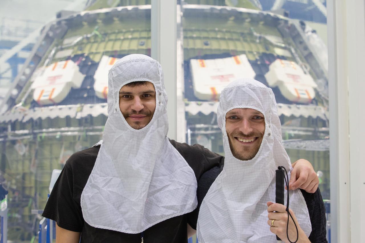 Two members of the rock band X Ambassadors are photographed in front of NASA’s Artemis II Orion crew module inside the Neil Armstrong Operations and Checkout (O&C) Building high bay at the agency’s Kennedy Space Center in Florida. X Ambassadors visited Kennedy on Oct. 21, 2019, and had the opportunity to tour areas around the multi-user spaceport such as the O&C, Launch Complex 39B and Swamp Works. The title of the band’s latest album, Orion, led them to an up-close look at the spacecraft that will take humans farther than they’ve ever gone before. 