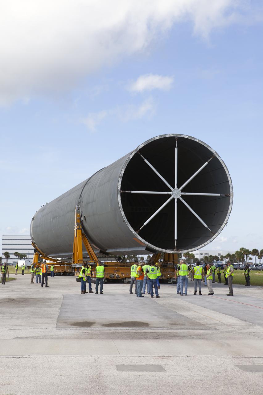 The top portion of the 212-foot-long Space Launch System (SLS) rocket core stage pathfinder is in view as the transporter it is secured on moves in reverse to position the pathfinder for the move to the Pegasus barge at the Launch Complex 39 turn basin wharf at NASA’s Kennedy Space Center in Florida on Oct. 28, 2019. The core stage pathfinder is a full-scale mock-up of the rocket's core stage. It was used by the Exploration Ground Systems Program and their contractor, Jacobs, to practice offloading, moving and stacking maneuvers inside the Vehicle Assembly Building, using important ground support equipment to train employees and certify all the equipment works properly. The pathfinder was at Kennedy for about a month. It will make the trek back to NASA's Michoud Assembly Facility in Louisiana.