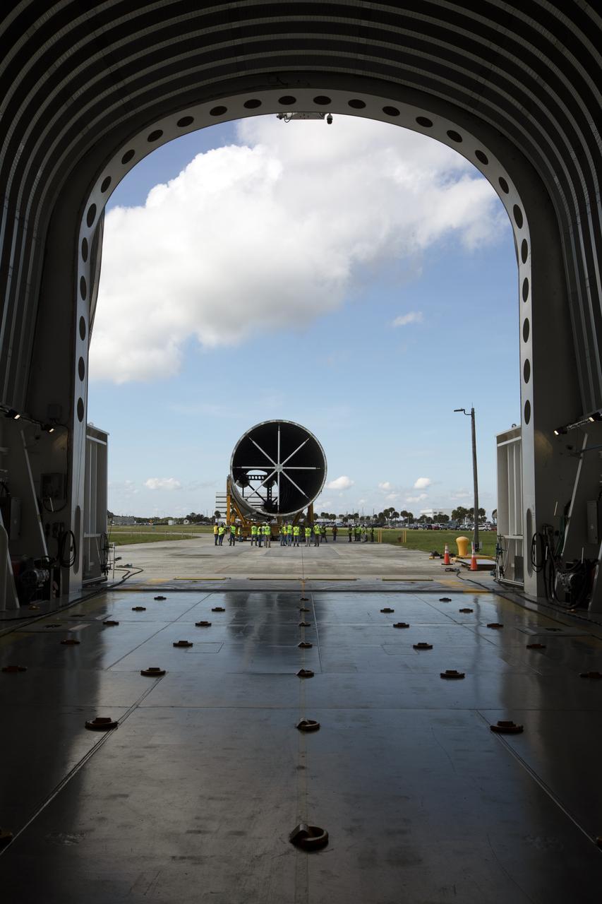 The 212-foot-long Space Launch System (SLS) rocket core stage pathfinder nears the entrance ramp to the Pegasus barge at the Launch Complex 39 turn basin wharf at NASA’s Kennedy Space Center in Florida on Oct. 28, 2019. The core stage pathfinder is a full-scale mock-up of the rocket's core stage. It was used by the Exploration Ground Systems Program and their contractor, Jacobs, to practice offloading, moving and stacking maneuvers inside the Vehicle Assembly Building, using important ground support equipment to train employees and certify all the equipment works properly. The pathfinder was at Kennedy for about a month. It will make the trek back to NASA's Michoud Assembly Facility in Louisiana.