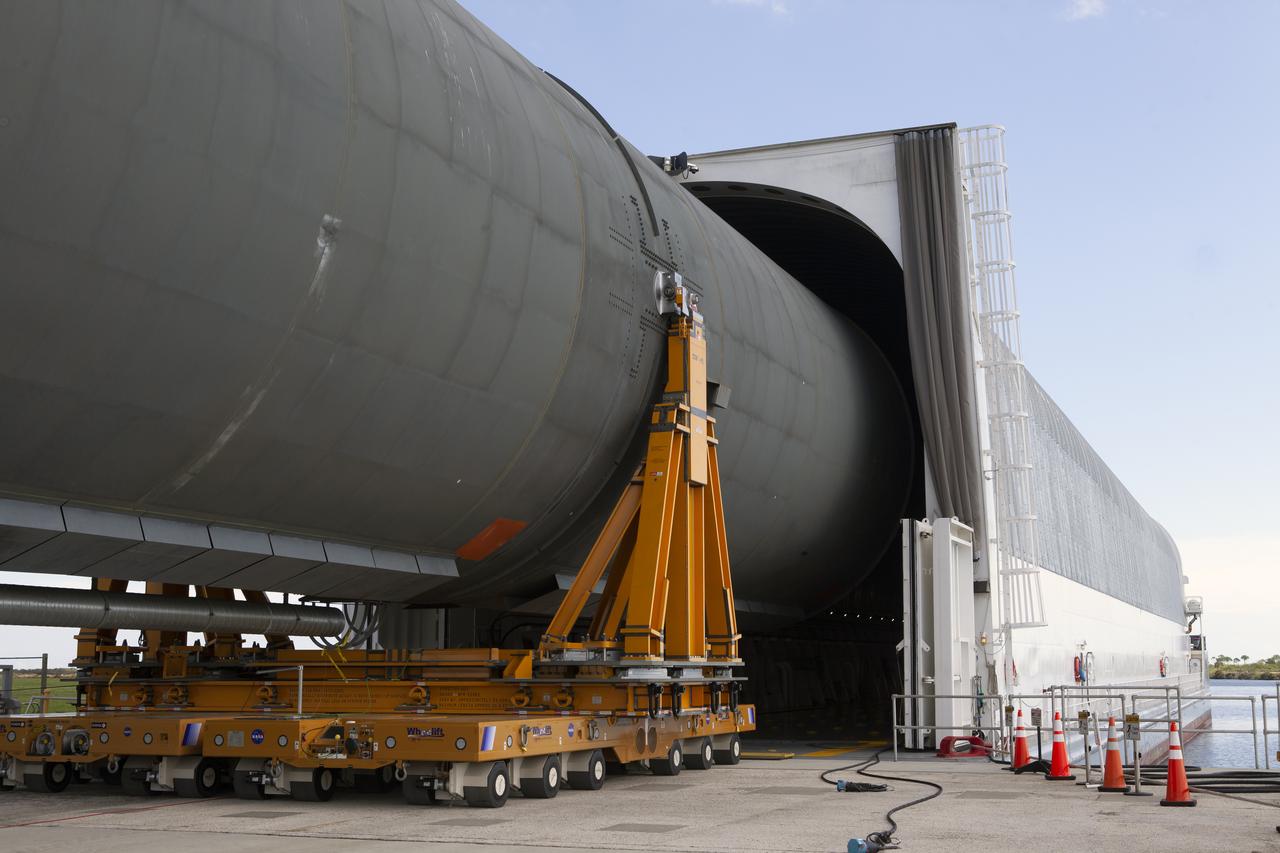 The 212-foot-long Space Launch System (SLS) rocket core stage pathfinder is moved inside the Pegasus barge at the Launch Complex 39 turn basin wharf at NASA’s Kennedy Space Center in Florida on Oct. 28, 2019. The core stage pathfinder is a full-scale mock-up of the rocket's core stage. It was used by the Exploration Ground Systems Program and their contractor, Jacobs, to practice offloading, moving and stacking maneuvers inside the Vehicle Assembly Building, using important ground support equipment to train employees and certify all the equipment works properly. The pathfinder was at Kennedy for about a month. It will make the trek back to NASA's Michoud Assembly Facility in Louisiana.