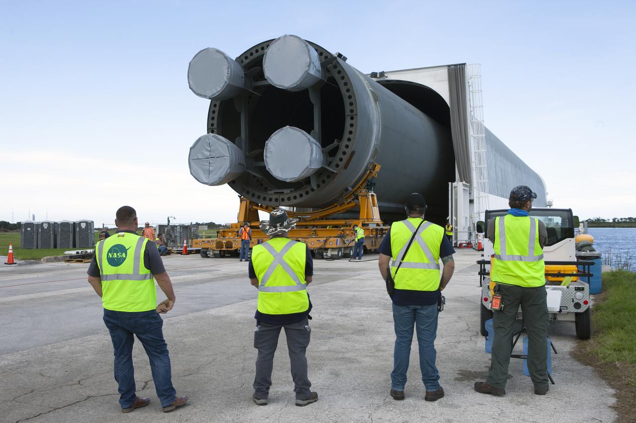 NASA and Jacobs workers watch as the 212-foot-long Space Launch System (SLS) rocket core stage pathfinder is moved inside the Pegasus barge at the Launch Complex 39 turn basin wharf at NASA’s Kennedy Space Center in Florida on Oct. 28, 2019. The core stage pathfinder is a full-scale mock-up of the rocket's core stage. It was used by the Exploration Ground Systems Program and their contractor, Jacobs, to practice offloading, moving and stacking maneuvers inside the Vehicle Assembly Building, using important ground support equipment to train employees and certify all the equipment works properly. The pathfinder was at Kennedy for about a month. It will make the trek back to NASA's Michoud Assembly Facility in Louisiana.