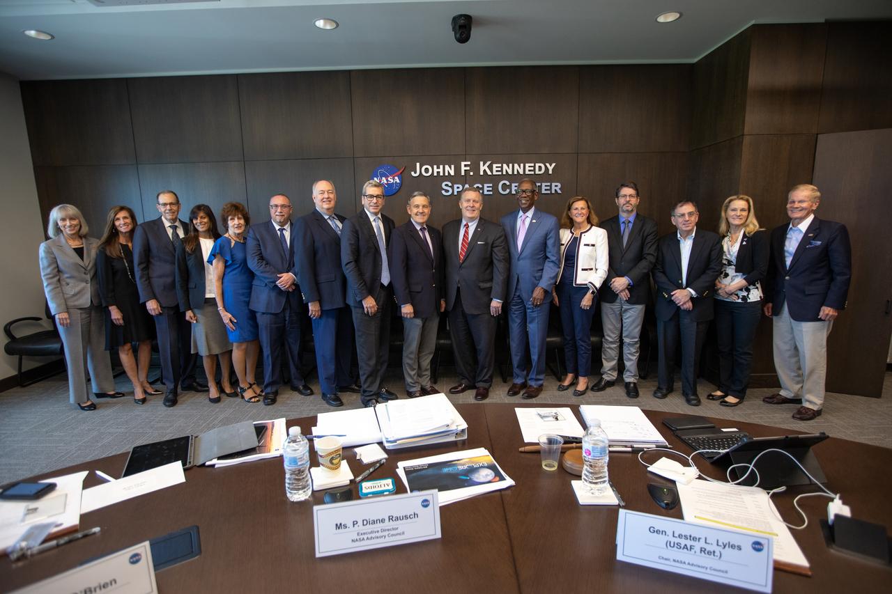 Members of the NASA Advisory Council pause for a group photograph during a meeting at the Kennedy Space Center Central Campus Headquarters Building in Florida on Oct. 31, 2019. In the center, at right, is NASA Deputy Administrator Jim Morhard. In the center, at left, is Kennedy Space Center Director Bob Cabana. The NASA Advisory Council provides the NASA administrator with counsel and advice on programs and issues of importance to the agency. Committee members conduct fact-finding sessions throughout the year in an effort to gain a broad understanding of current NASA issues and future mission implementation plans.