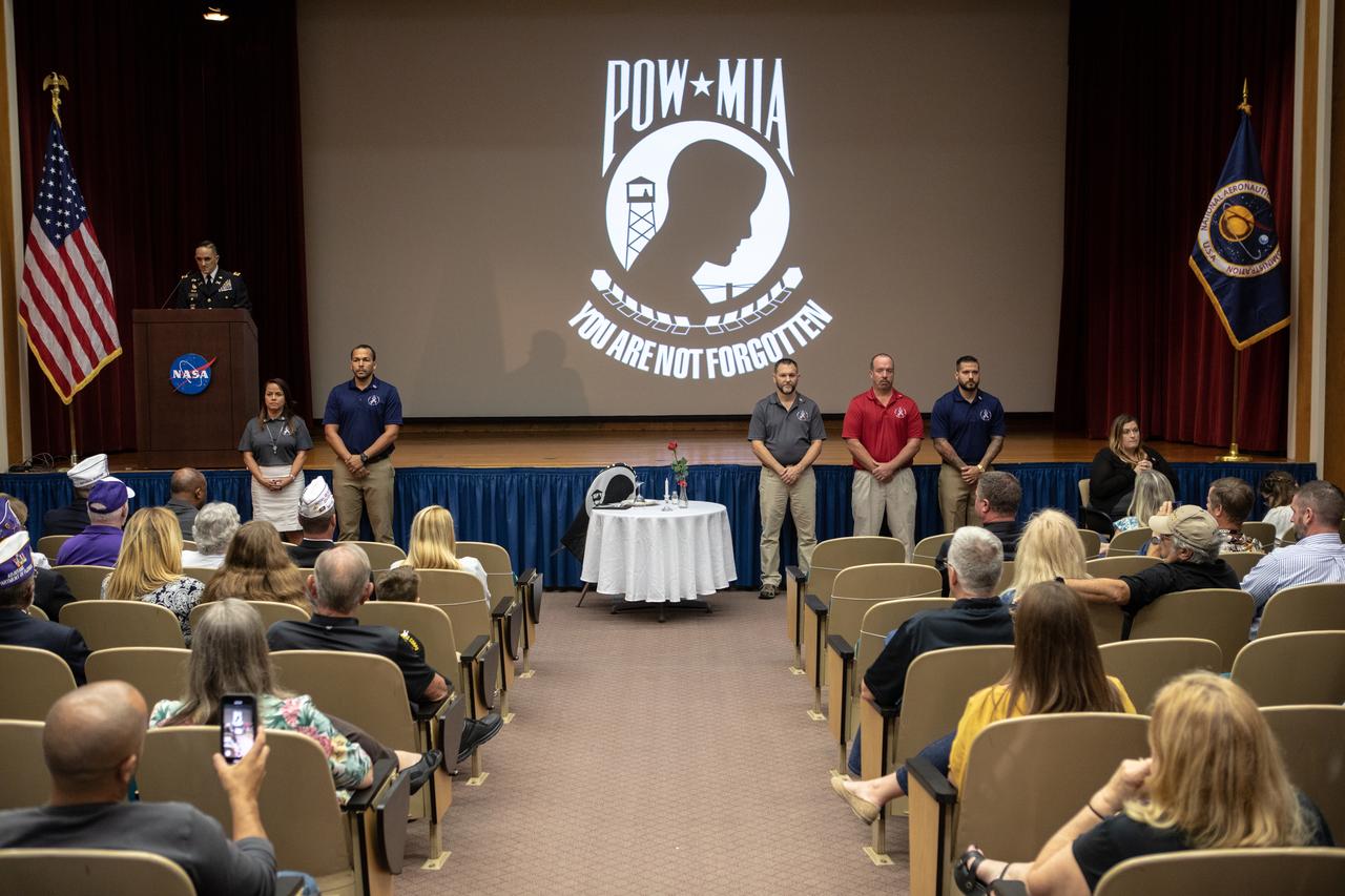 NASA Public Affairs Officer Dustin Cammack conducts a prisoner of war, missing in action ceremony at the start of a Veterans Day observance event on Nov. 7, 2019, at the Kennedy Space Center Training Auditorium in Florida. During the event, Kennedy was named a Purple Heart Entity by the Military Order of the Purple Heart, becoming the first NASA center to receive this designation for support and services provided to veterans through the spaceport’s Veterans employee resource group. Attendees included Kennedy employees and more than 20 Purple Heart recipients. Following the award presentation, Christopher Vedvick, a combat wounded veteran and Military Order of the Purple Heart department of Florida commander, spoke about his experience serving in the United States Army before retiring, his involvement in the Military Order of the Purple Heart and the purpose of the organization.