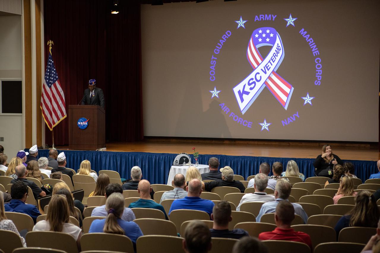 NASA Public Affairs Officer Derrick Matthews serves as emcee during a Veterans Day observance event on Nov. 7, 2019, at the Kennedy Space Center Training Auditorium in Florida. During the event, Kennedy was named a Purple Heart Entity by the Military Order of the Purple Heart, becoming the first NASA center to receive this designation for support and services provided to veterans through the spaceport’s Veterans employee resource group. Attendees included Kennedy employees and more than 20 Purple Heart recipients. Following the award presentation, Christopher Vedvick, a combat wounded veteran and Military Order of the Purple Heart department of Florida commander, spoke about his experience serving in the United States Army before retiring, his involvement in the Military Order of the Purple Heart and the purpose of the organization. 