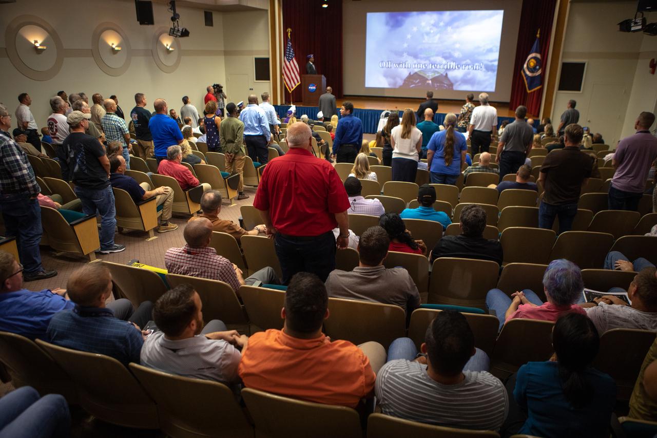 Kennedy Space Center employees attend a Veterans Day observance event on Nov. 7, 2019, in the Florida spaceport’s Training Auditorium. Those employees standing are being recognized for serving in the United States Armed Forces. During the event, Kennedy was named a Purple Heart Entity by the Military Order of the Purple Heart, becoming the first NASA center to receive this designation for support and services provided to veterans through the center’s Veterans employee resource group. Following this recognition, Christopher Vedvick, a combat wounded veteran and Military Order of the Purple Heart department of Florida commander, spoke about his experience serving in the United States Army before retiring, his involvement in the Military Order of the Purple Heart and the purpose of the organization. 