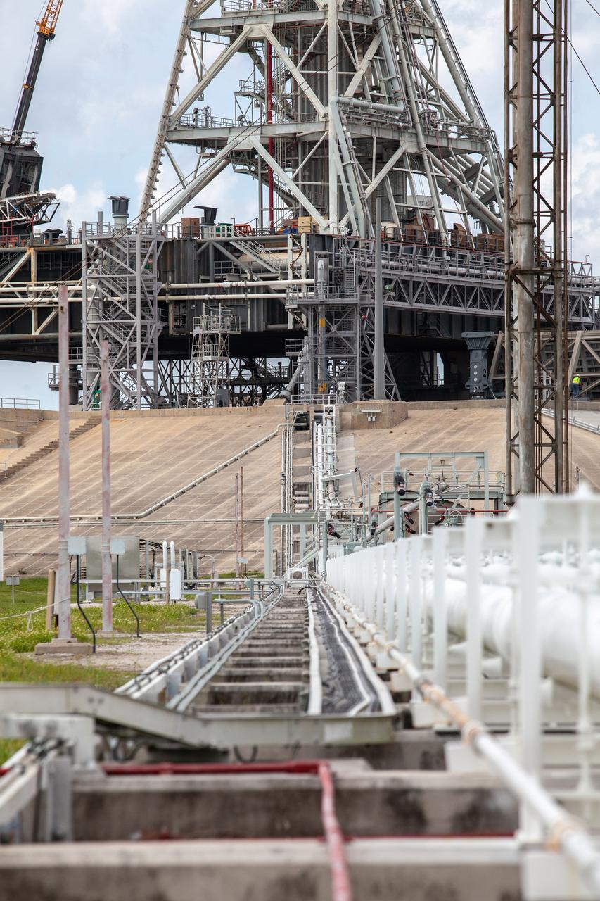 In this view, the cross country line that liquid hydrogen will flow through can be seen stretching from the storage tank to the mobile launcher (ML) at Launch Pad 39B on Nov. 8, 2019, at NASA’s Kennedy Space Center in Florida. The agency’s Exploration Ground Systems oversaw testing of the pad’s cryogenic systems – the infrastructure that will send liquid hydrogen and liquid oxygen from the storage tanks to the Space Launch System (SLS) rocket – in preparation for the launch of SLS with the Orion spacecraft atop for the uncrewed Artemis I mission. Each of the liquid hydrogen and liquid oxygen tanks can hold more than 800,000 gallons of propellant. The liquid hydrogen, lighter than liquid oxygen, will make its way from the tank to the rocket using gaseous hydrogen to pressurize the sphere at the time of launch, while the liquid oxygen will be sent to the rocket via pumps. 