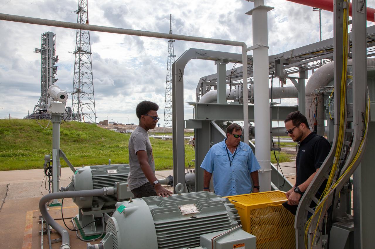 From left, liquid oxygen engineers Josh Jones, Jim Loup and Rene DeLaCruz on Kennedy Space Center’s Test Operations and Support Contract inspect equipment surrounding the liquid oxygen storage tank at Launch Pad 39B on Nov. 8, 2019. The agency’s Exploration Ground Systems oversaw testing of the pad’s cryogenic systems – the infrastructure that will support the flow of liquid hydrogen and liquid oxygen from the storage tanks to the Space Launch System (SLS) rocket – in preparation for the launch of SLS with the Orion spacecraft atop for the uncrewed Artemis I mission. Each of the liquid oxygen and liquid hydrogen tanks can hold more than 800,000 gallons of propellant. The liquid oxygen will require the use of pumps to push it from the tank to the rocket, while the lighter liquid hydrogen will make its way up to the pad using gaseous hydrogen to pressurize the sphere. 