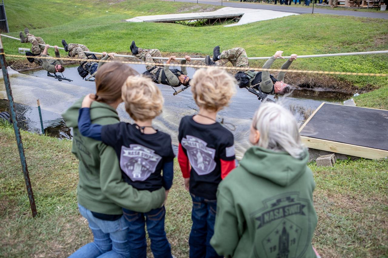 The family of one of NASA Kennedy Space Center's Emergency Response Team members watches the 37th Annual SWAT Round-Up International at the Lawson Lamar Firearms and Tactical Training Center in Orlando, Florida. Kennedy’s ERT members are working their way along a rope. The competition was held Nov. 10 to 15, and featured five different competition categories. Kennedy's ERT members exchanged best practices and competed with 60 teams from the U.S. and around the world.