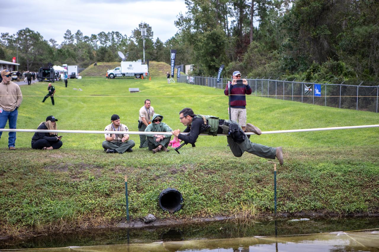 A member of NASA Kennedy Space Center's Emergency Response Team works his way along a rope above water during one of the tactical challenges at the 37th Annual SWAT Round-Up International at the Lawson Lamar Firearms and Tactical Training Center in Orlando, Florida. The competition was held Nov. 10 to 15, 2019, and featured five different tactical challenges. Kennedy's ERT members exchanged best practices and competed with more than 50 teams from the U.S. and around the world.