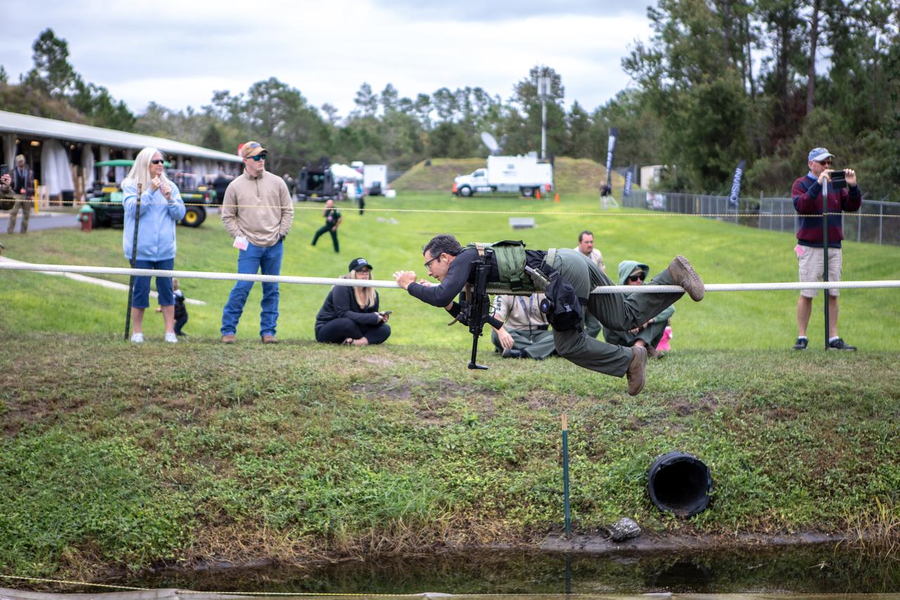 A member of NASA Kennedy Space Center's Emergency Response Team works his way along a rope above water during one of the tactical challenges at the 37th Annual SWAT Round-Up International at the Lawson Lamar Firearms and Tactical Training Center in Orlando, Florida. The competition was held Nov. 10 to 15, 2019, and featured five different tactical challenges. Kennedy's ERT members exchanged best practices and competed with more than 50 teams from the U.S. and around the world.