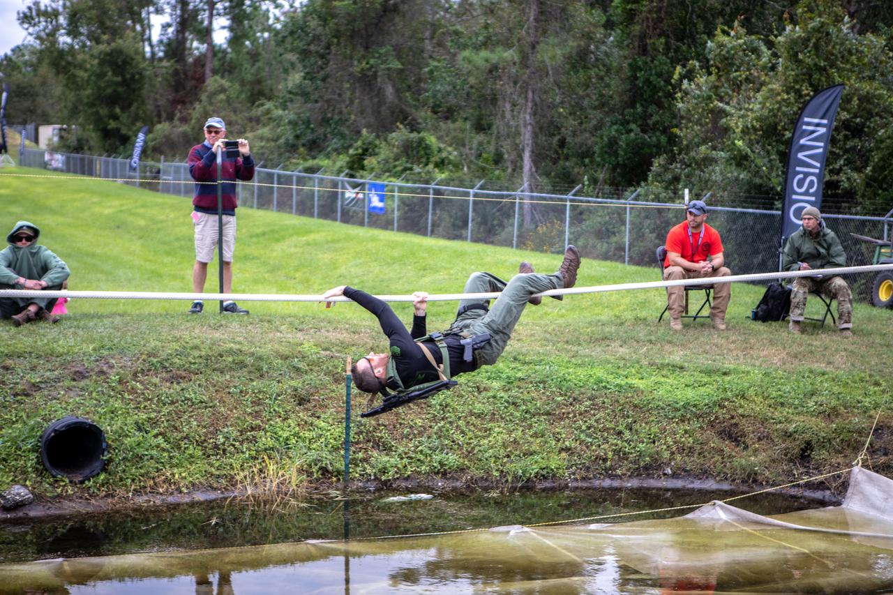 A member of NASA Kennedy Space Center's Emergency Response Team switches position as he works his way along a rope above water during one of the tactical challenges at the 37th Annual SWAT Round-Up International at the Lawson Lamar Firearms and Tactical Training Center in Orlando, Florida. The competition was held Nov. 10 to 15, 2019, and featured five different tactical challenges. Kennedy's ERT members exchanged best practices and competed with more than 50 teams from the U.S. and around the world.