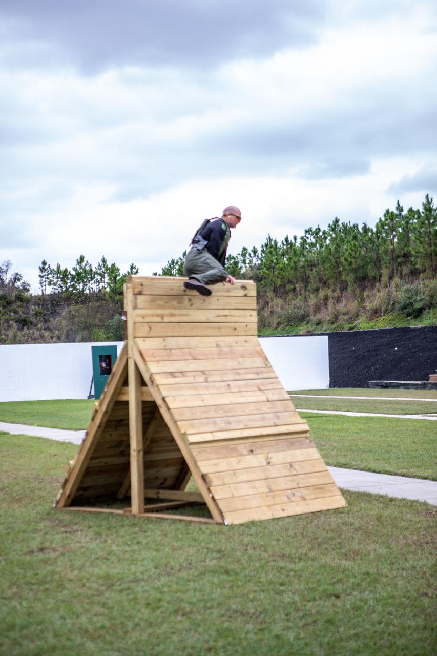 A member of NASA Kennedy Space Center's Emergency Response Team scales over a wall during one of the tactical challenges at the 37th Annual SWAT Round-Up International at the Lawson Lamar Firearms and Tactical Training Center in Orlando, Florida. The competition was held Nov. 10 to 15, 2019, and featured five different tactical challenges. Kennedy's ERT members exchanged best practices and competed with more than 50 teams from the U.S. and around the world.