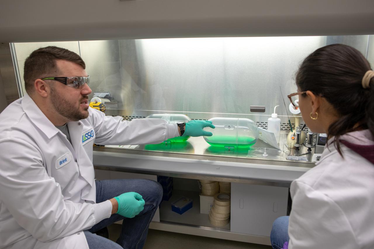 Kennedy Space Center’s Brint Bauer, left, and Carolina Franco, Ph.D., conduct a biological study on two tanks of water, filled with green dye, in the Florida spaceport’s Neil Armstrong Operations and Checkout Building on Nov. 13, 2019. The tanks have recently returned to Kennedy after spending the last five years on the International Space Station for an experiment to study slosh, or the movement of water, in a zero-gravity environment to help engineers predict the movement of propellant in rocket tanks. Kennedy’s Air and Water Revitalization lab is studying the water tanks to determine if there is, or was, any microbial growth within them. The results will help NASA determine whether clean water can be stored in space for long-duration missions, an essential component to keeping astronauts safe and healthy as the agency prepares for missions to the Moon and beyond to Mars. 